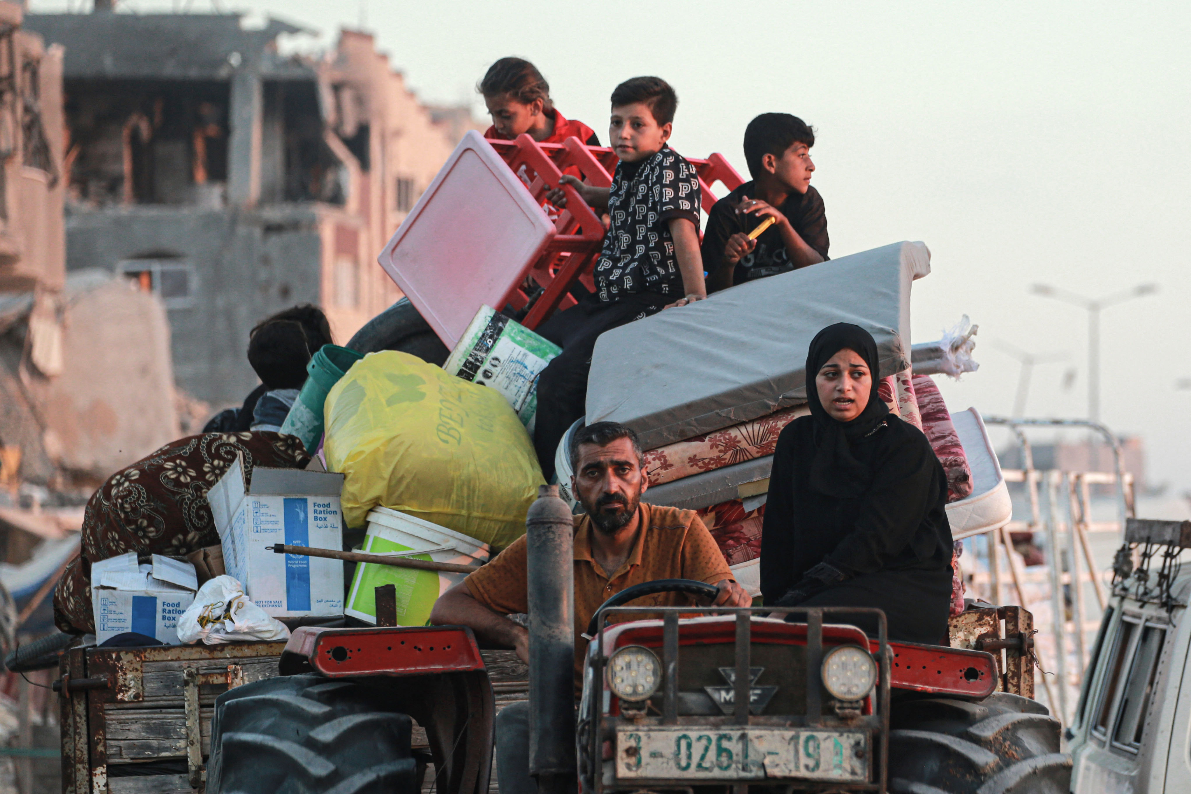 Displaced Palestinians leave an area in east Khan Younis