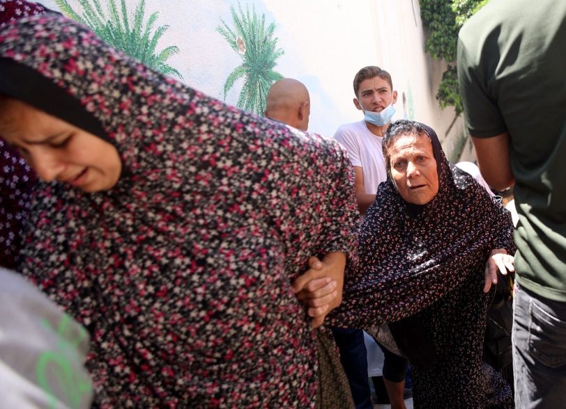 Palestinian women flee the area of the Latin Patriarchate Holy Family School following a warning by the Israeli military to evacuate during the Israeli military bombardment of Gaza City