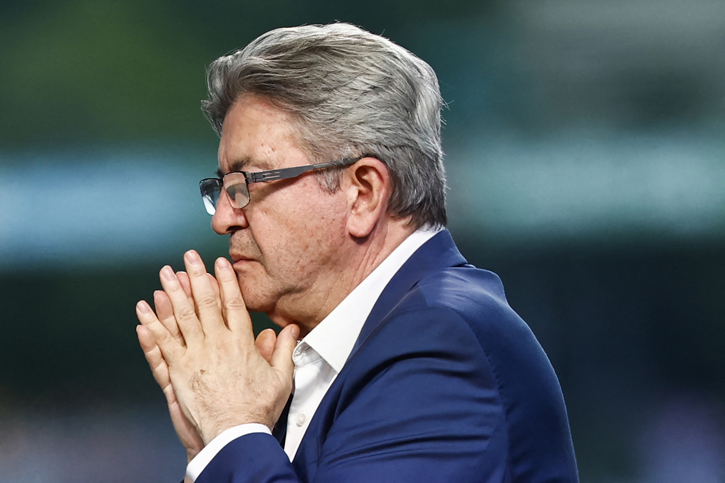 Founder of left-wing party La France Insoumise (LFI) Jean-Luc Melenchon reacts during the election night of left-wing party La France Insoumise (LFI) following the first results of the second round of France's legislative election at La Rotonde Stalingrad in Paris on July 7, 2024. - A broad left-wing coalition was leading a tight French legislative election, ahead of both President's centrists and the far right with no group winning an absolute majority, projections showed. (Photo by Sameer Al-Doumy / AFP)