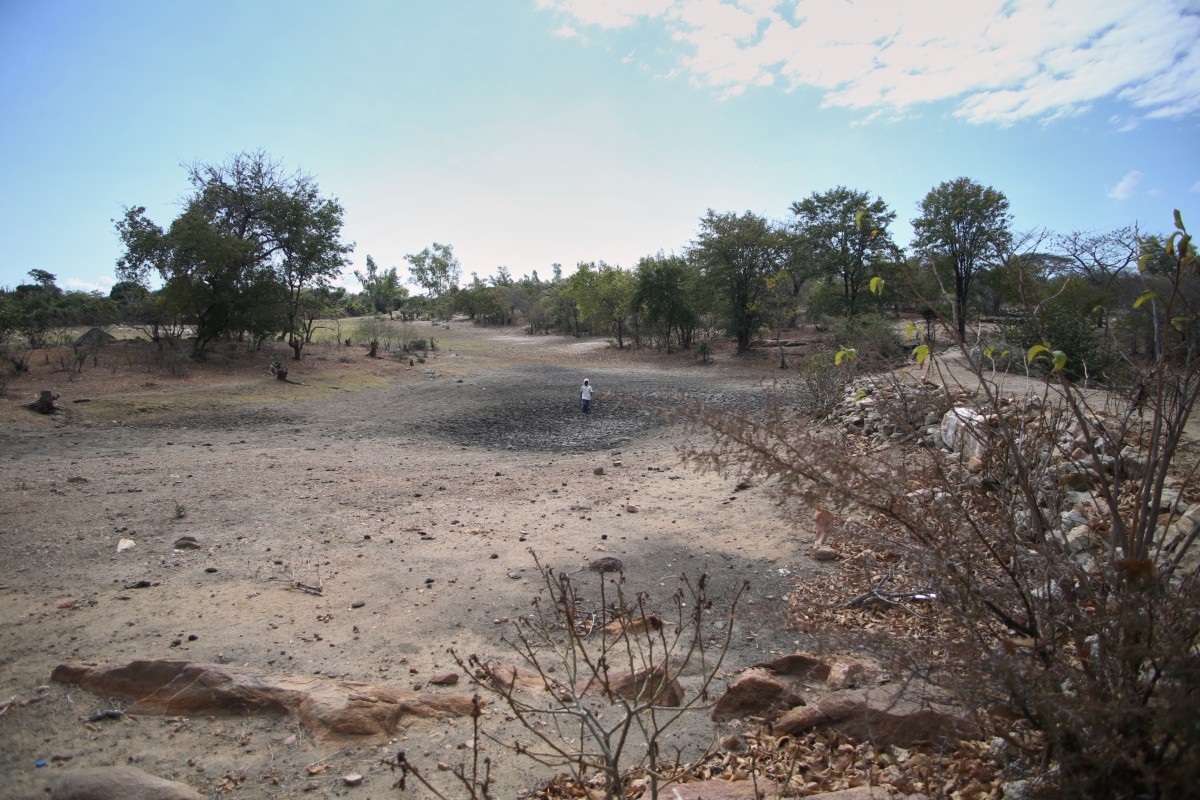 Farmer Takesure Chimbu walks on the dry bed of the Kapotesa dam