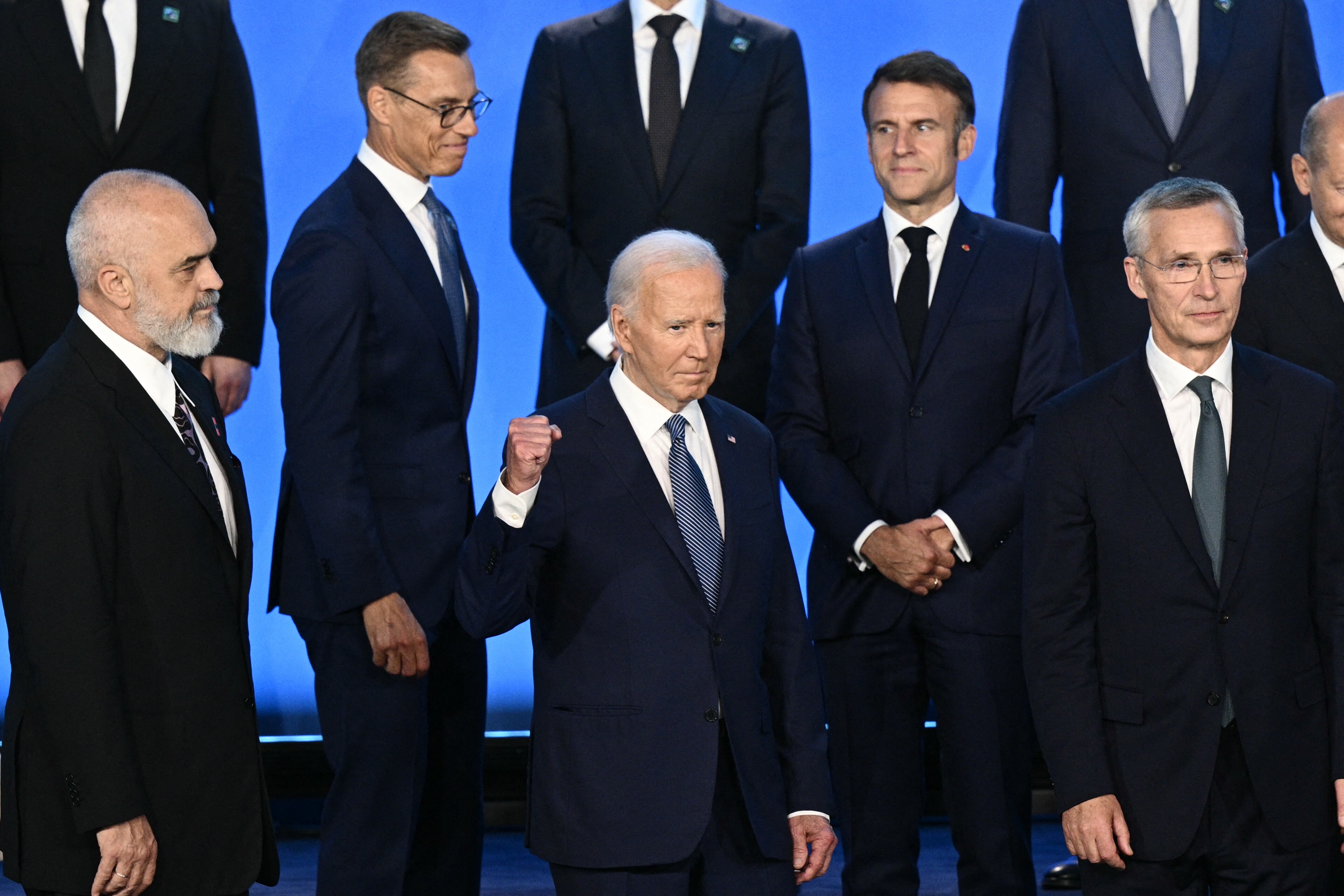 US President Joe Biden gestures as the NATO heads of state pose for a family photo during the NATO 75th anniversary summit at the Walter E. Washington Convention Center in Washington, DC, on July 10, 2024.