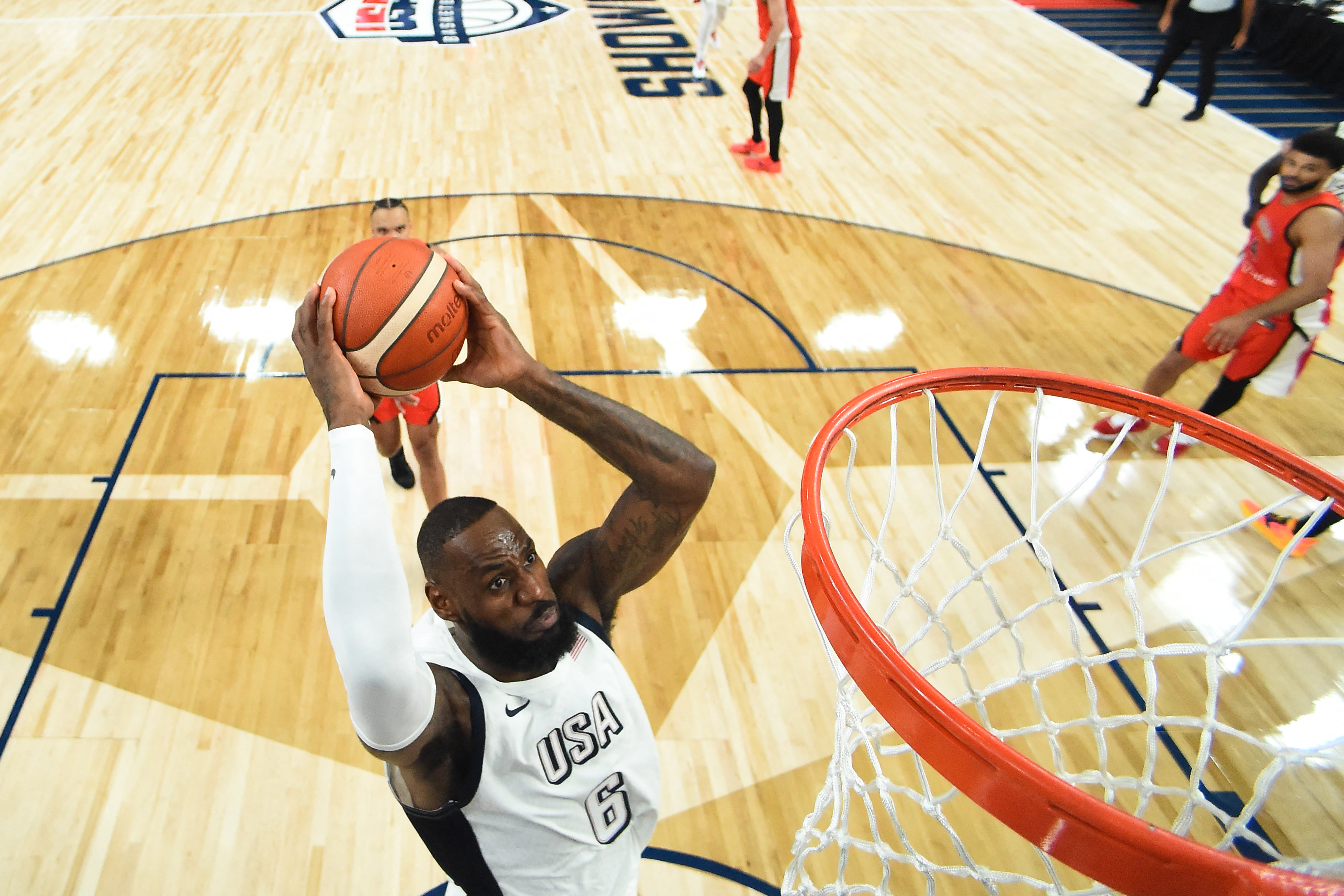 Basketball player dunks ball.