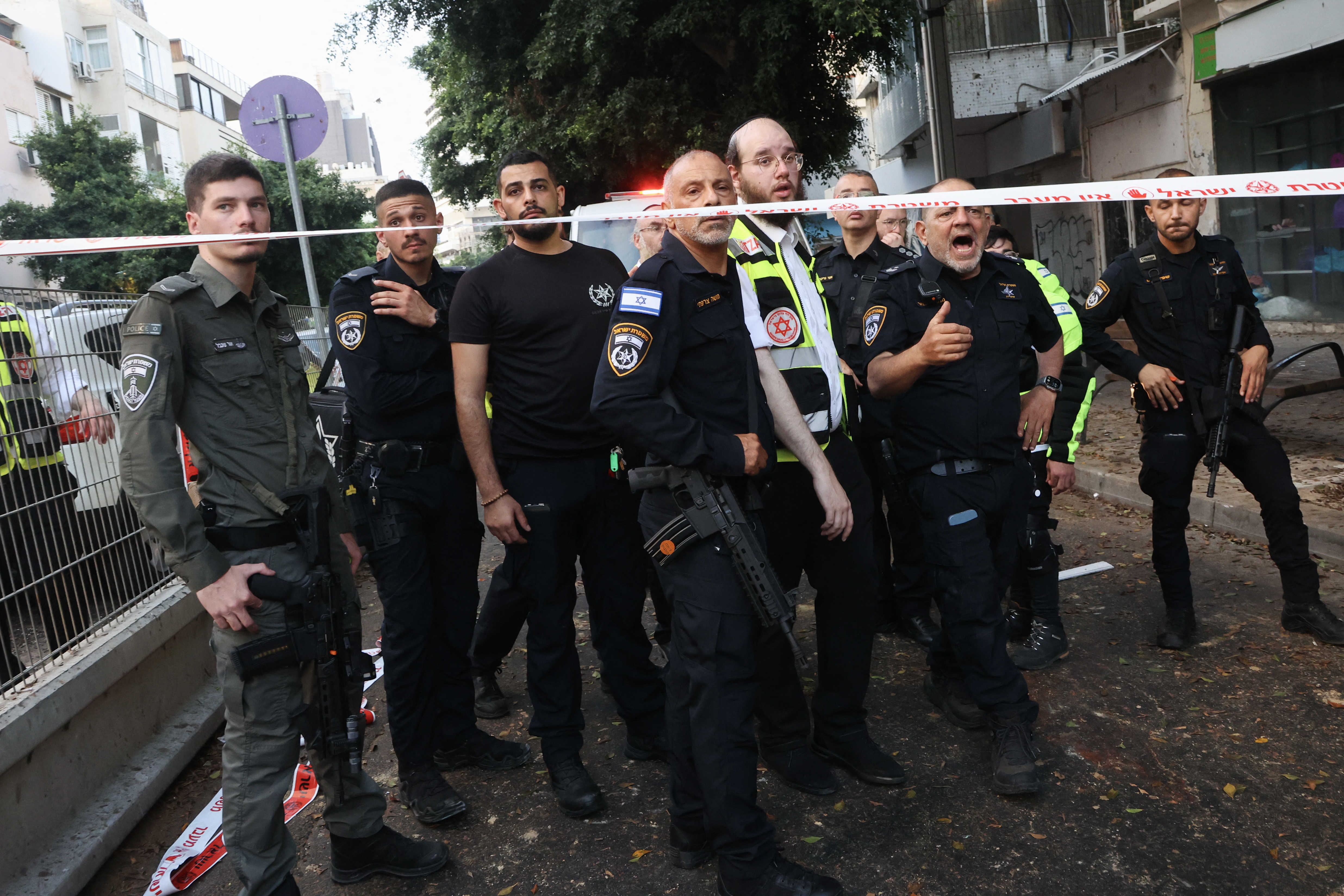 Israeli policemen search the scene where an explosion took place in Tel Aviv on July 19, 2024. Yemen's Iran-backed Huthi rebels on July 19, claimed responsibility for a drone attack on the Israeli city of Tel Aviv, where police said one person was found dead. The rebels fired a "new drone called 'Yafa', which is capable of bypassing the enemy's interception systems," Huthi military spokesman Yahya Saree said in a statement on social media.(Photo by GIL COHEN-MAGEN / AFP)