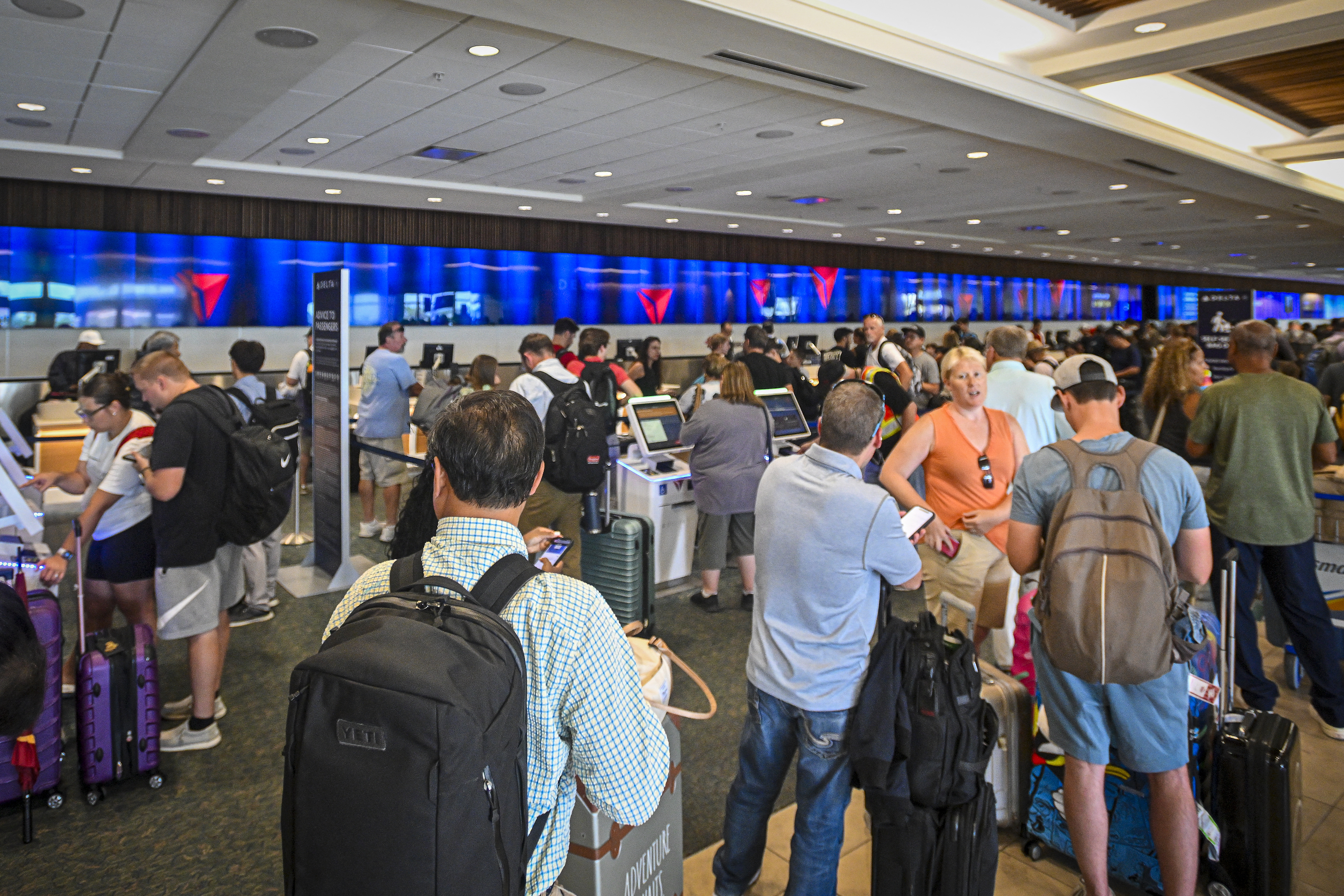 ORLANDO, FLORIDA - JULY 19: Passengers wait on long queues at check-in counters due to the global communications outage caused by CrowdStrike at Orlando International Airport on July 19, 2024, in Orlando, Florida. Businesses and airlines worldwide continue to be affected by a global technology outage attributed to a software update administered by CrowdStrike, a cybersecurity firm whose software is used by various industries around the world. Miguel J. Rodriguez Carrillo/Getty Images/AFP (Photo by Miguel J. Rodriguez Carrillo / GETTY IMAGES NORTH AMERICA / Getty Images via AFP)
