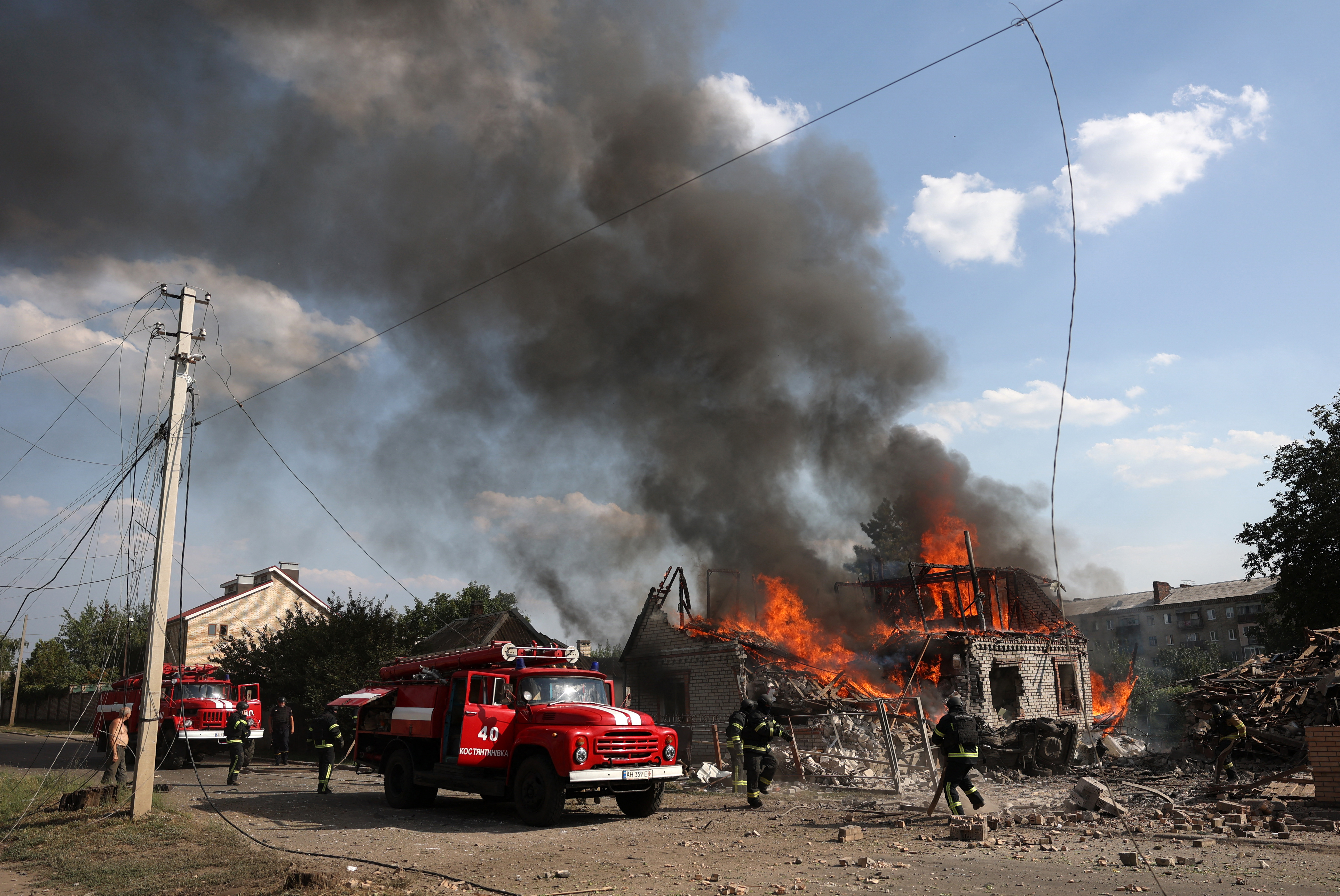 Rescuers put out a fire in a private house destroyed during a missile attack in Kostyatynivka town, Donetsk region, on July 21, 2024, amid the Russian invasion in Ukraine.