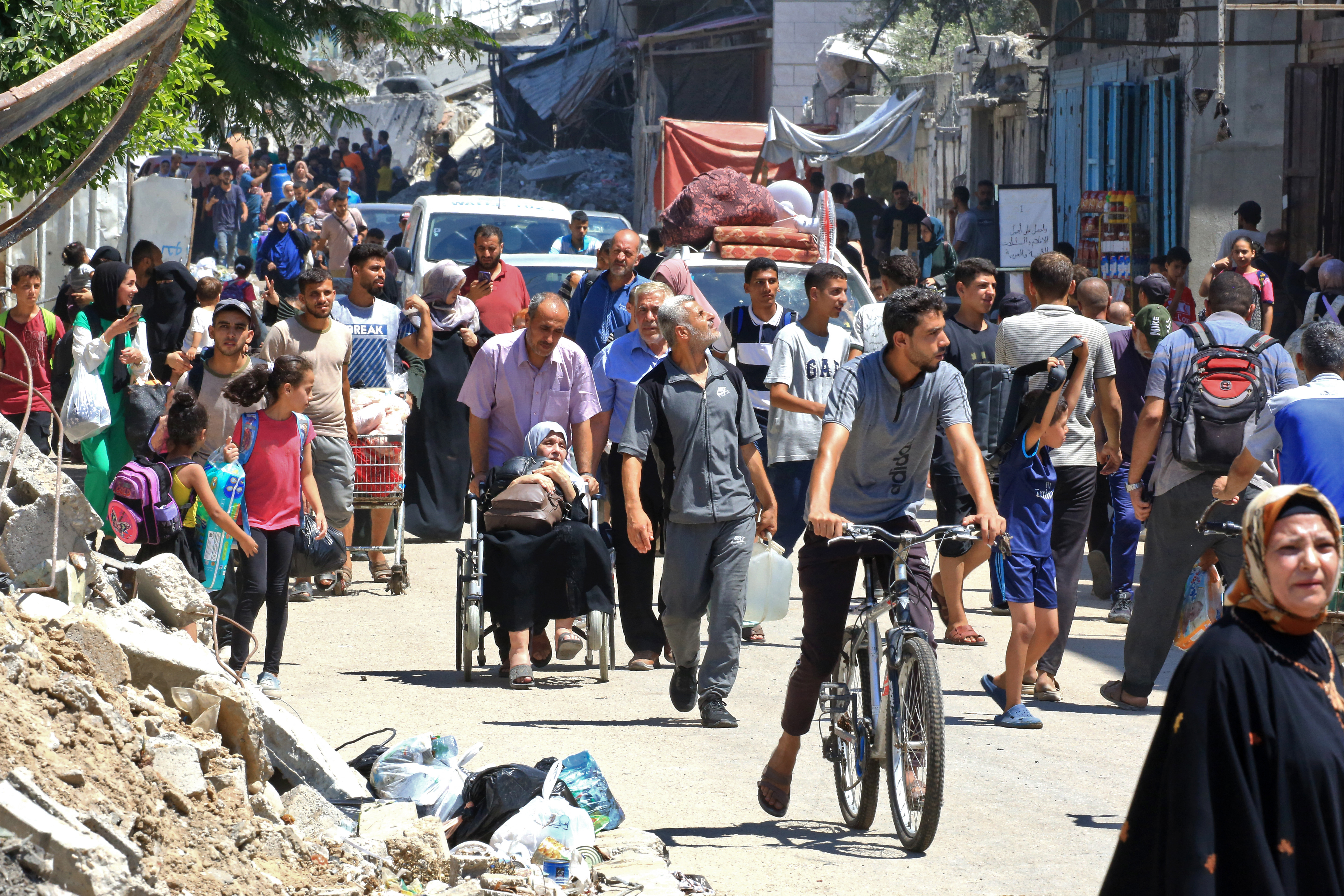 People flee al-Bureij refugee camp in the central Gaza Strip following Israeli bombardment on July 23, 2024
