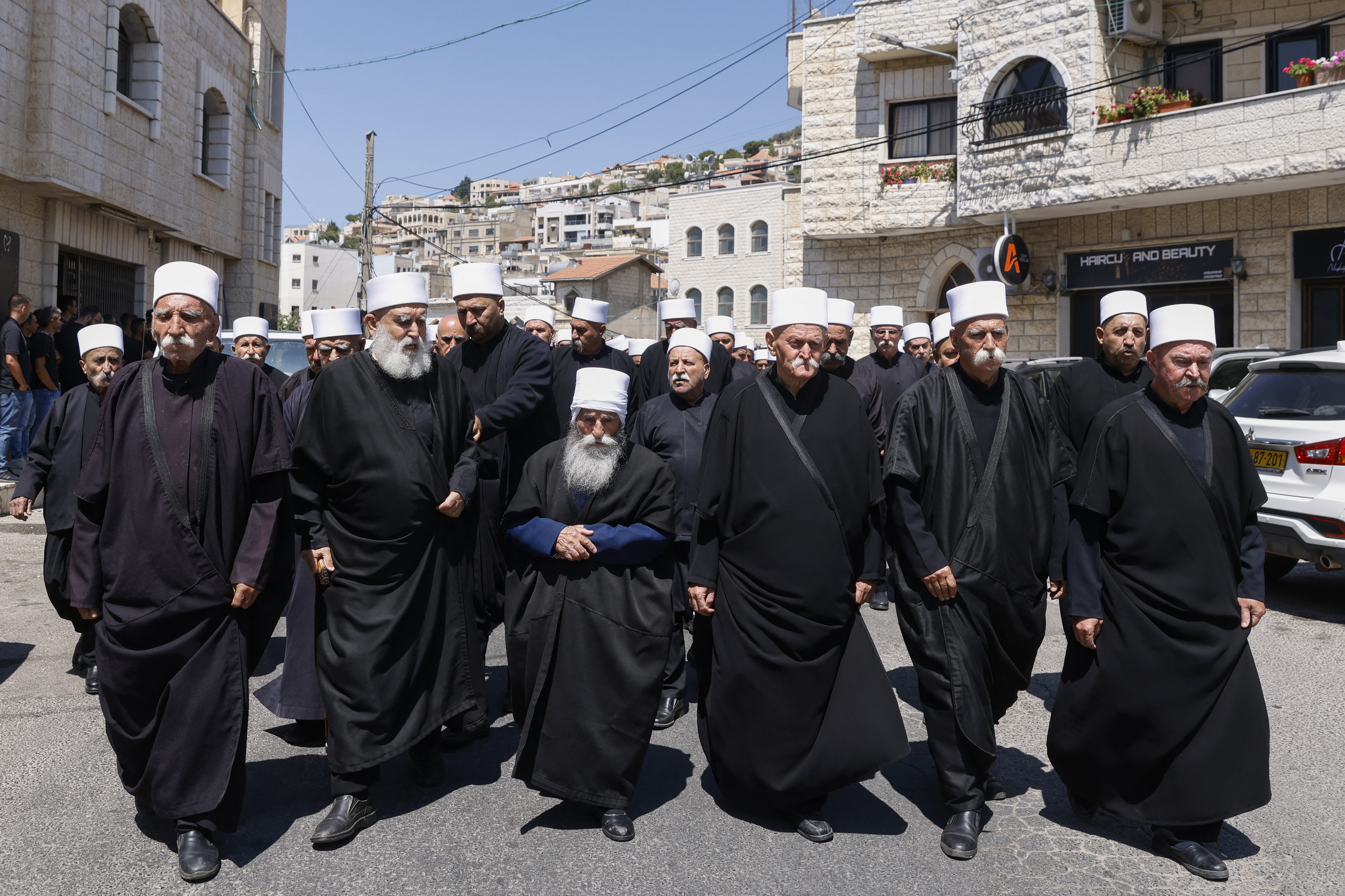 Elders and mourners attend the funeral of Guevara Ibrahim, 11, killed in a reported strike from Lebanon two days earlier, in the Druze town of Majdal Shams in the Israeli-annexed Golan