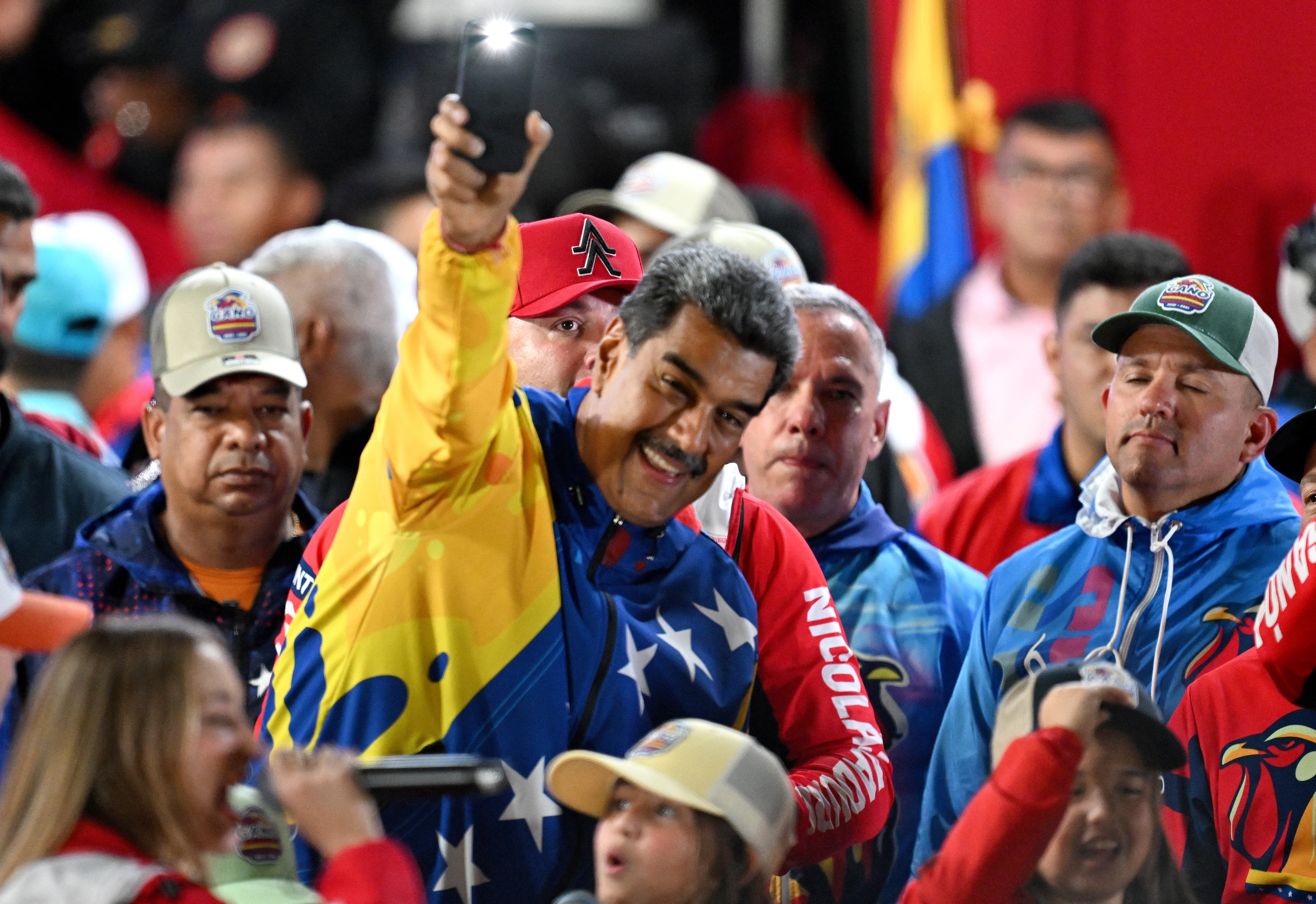 Maduro surrounded by supporters after he was announced the election winner. He looks happy.