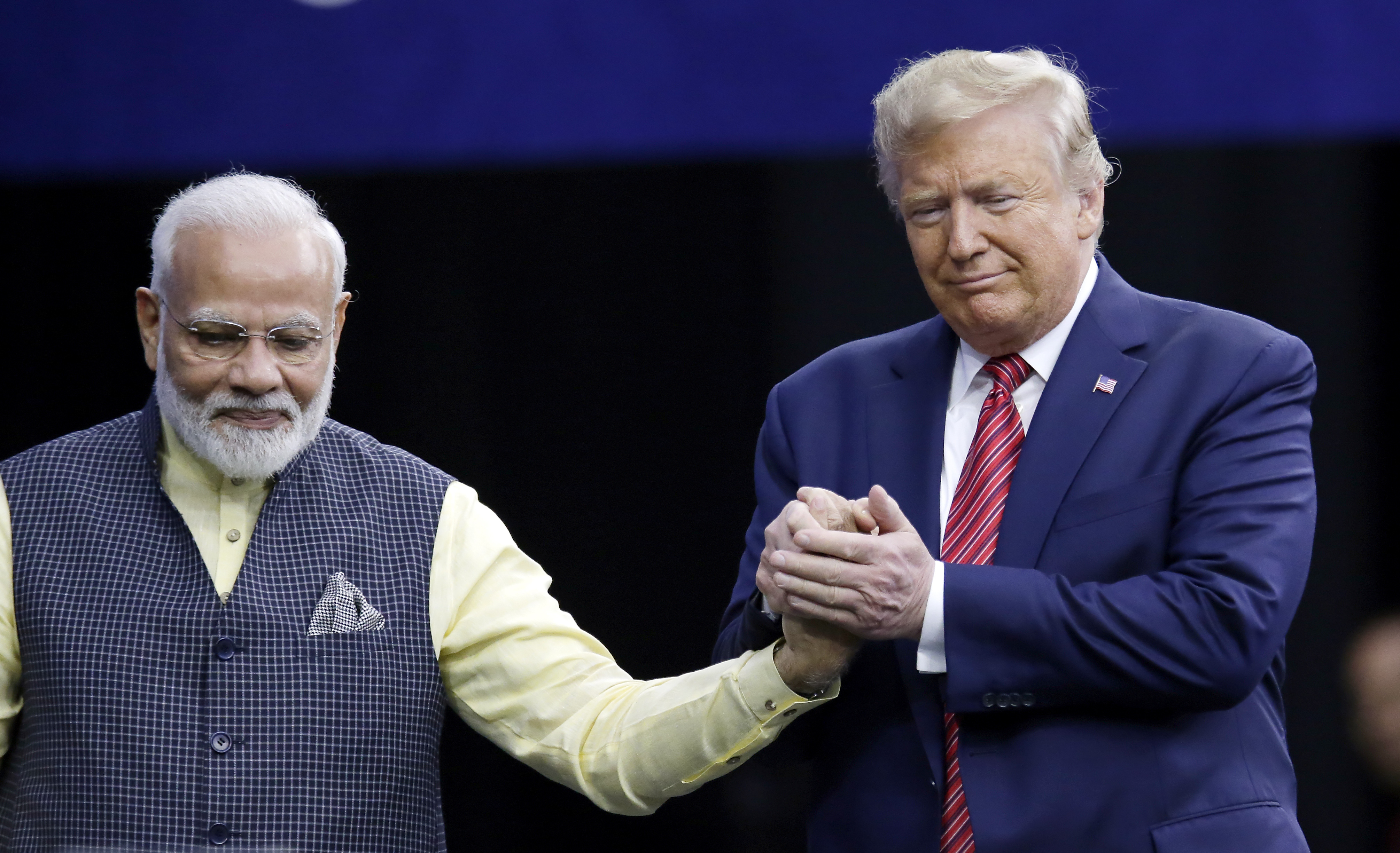Prime Minister Narendra Modi and President Donald Trump shake hands after introductions during the "Howdi Modi" event Sunday, Sept. 22, 2019, at NRG Stadium in Houston. (AP Photo/Michael Wyke)