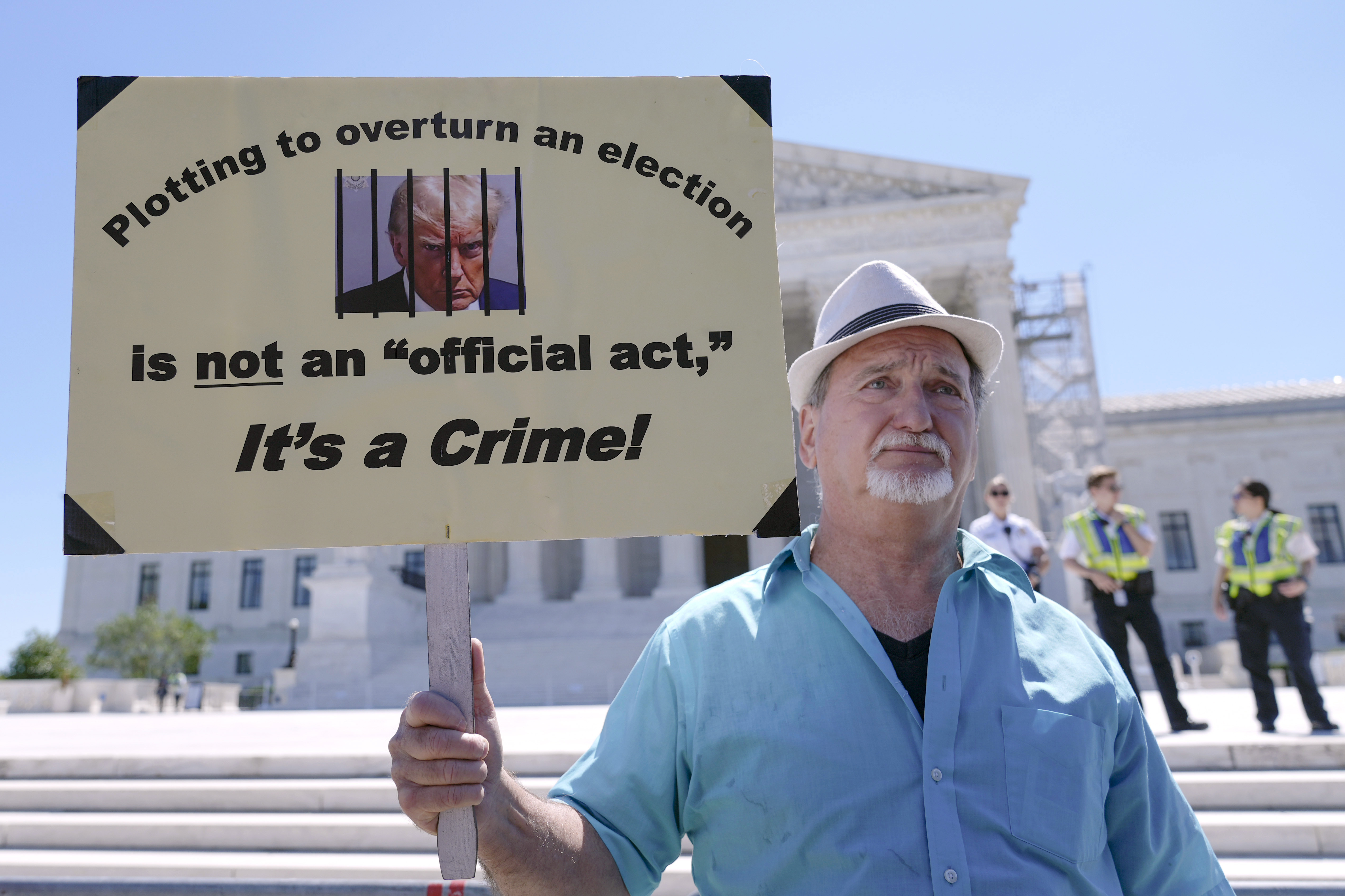 Gary Roush, of College Park, Md., protests outside the Supreme Court Monday