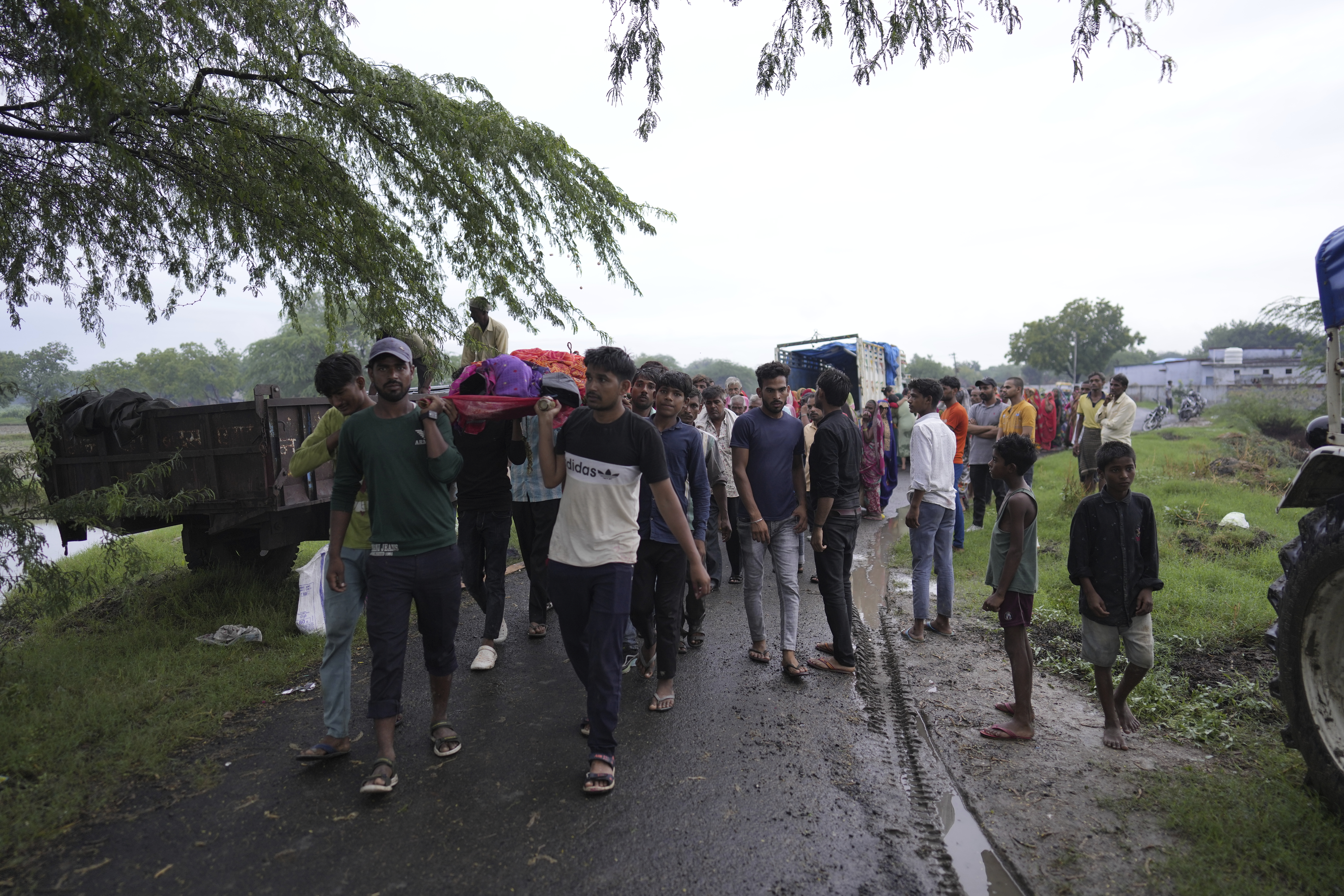 Family members and neighbors carry the body Savitri Devi,