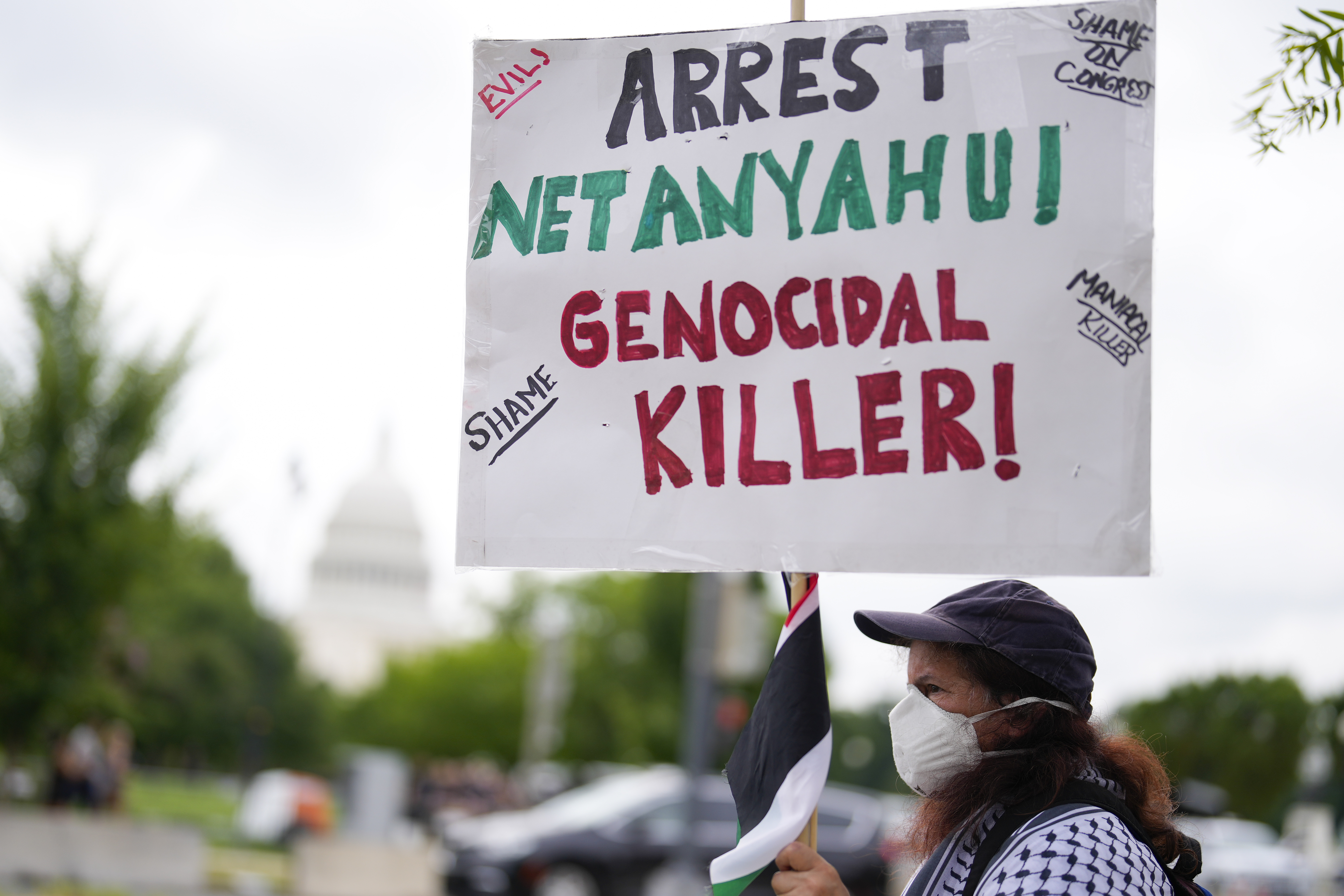 Demonstrators protest near the Capitol during a visit by Israeli Prime Minister Benjamin Netanyahu