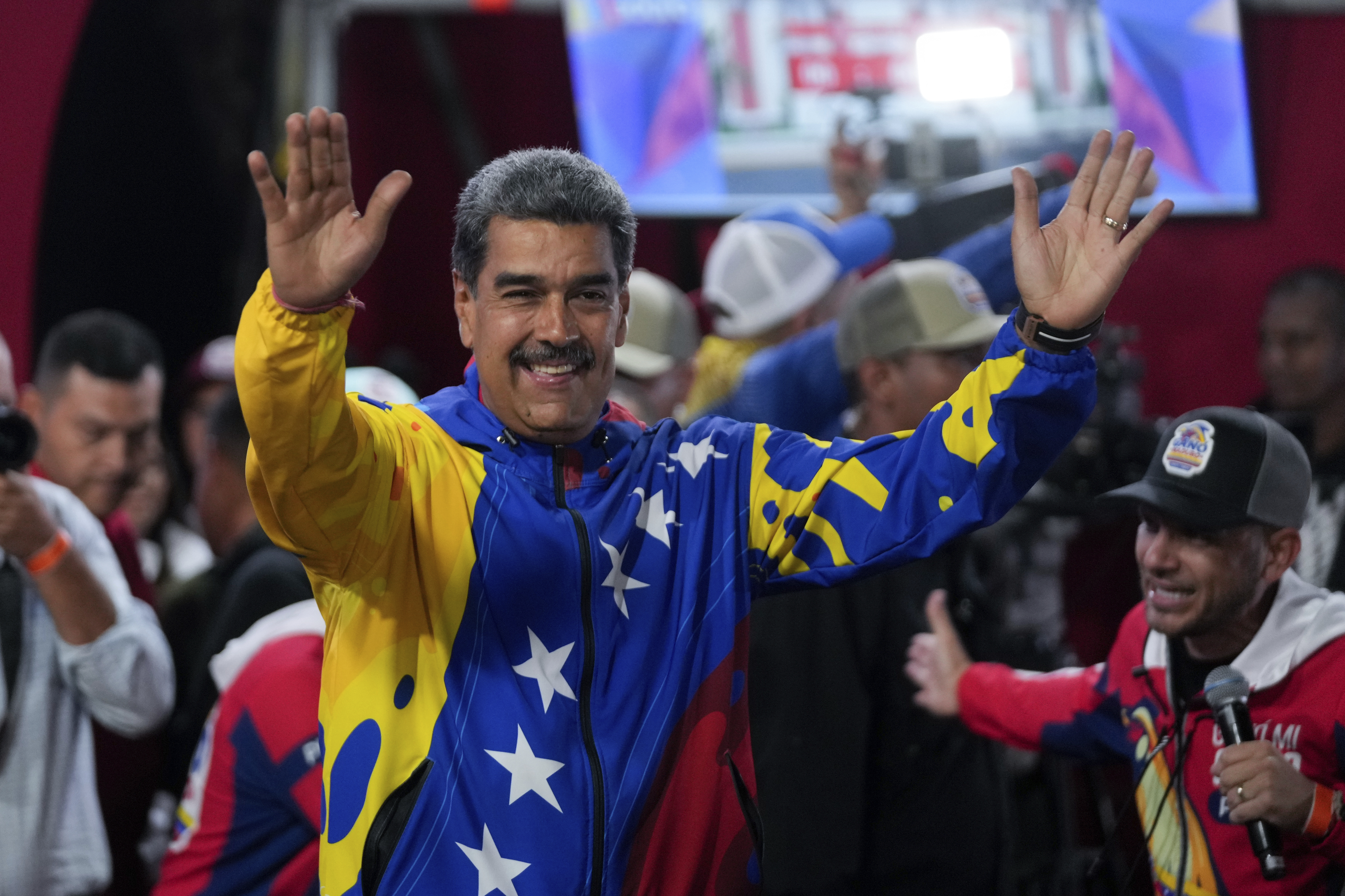 President Nicolas Maduro addresses supporters gathered outside the Miraflores presidential palace after electoral authorities declared him the winner of the presidential election in Caracas, Venezuela, Monday,
