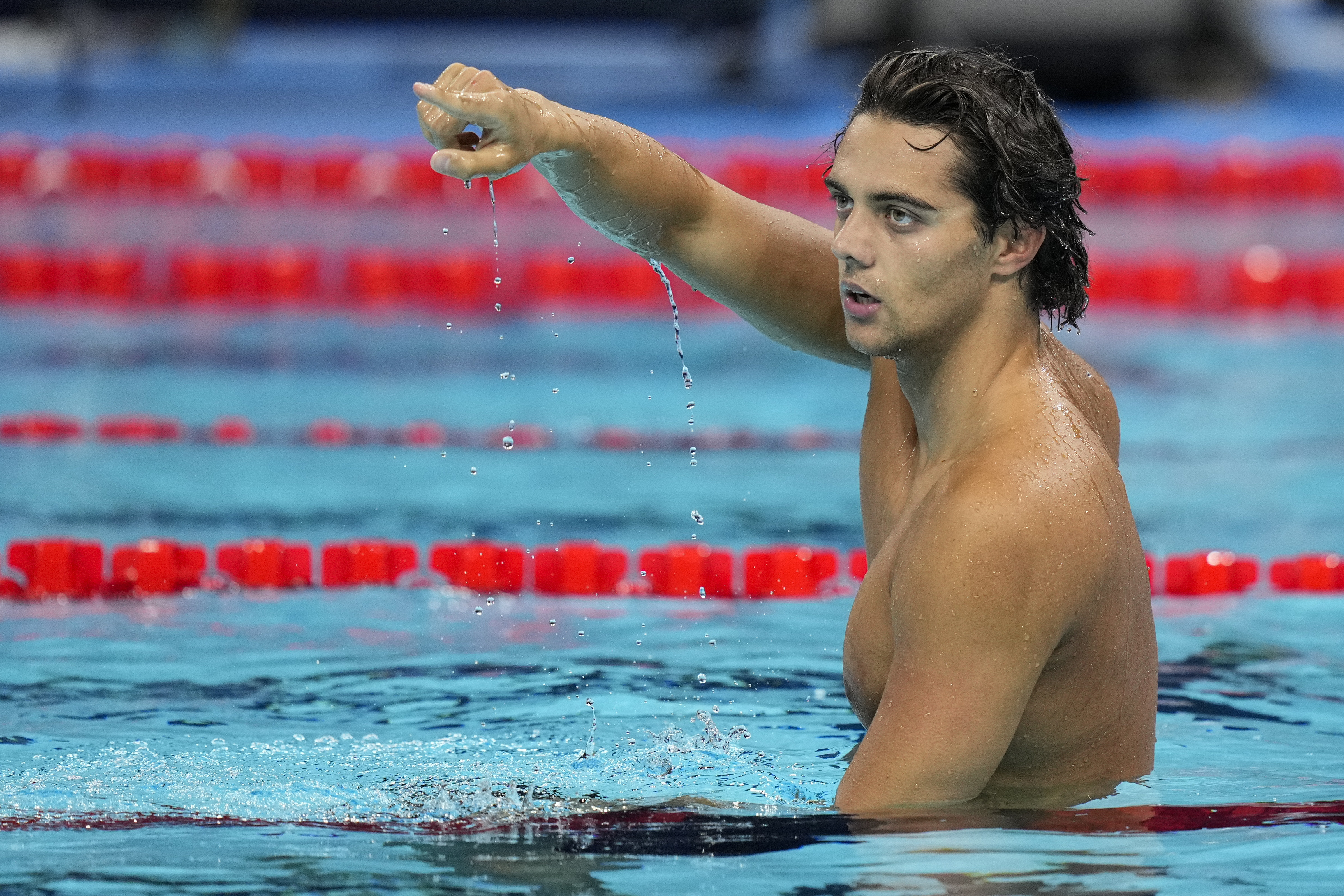 Thomas Ceccon, of Italy, reacts after winning the men's 100-meter backstroke final at the 2024 Summer Olympics, Monday, July 29, 2024, in Nanterre, France. (AP Photo/Bernat Armangue)