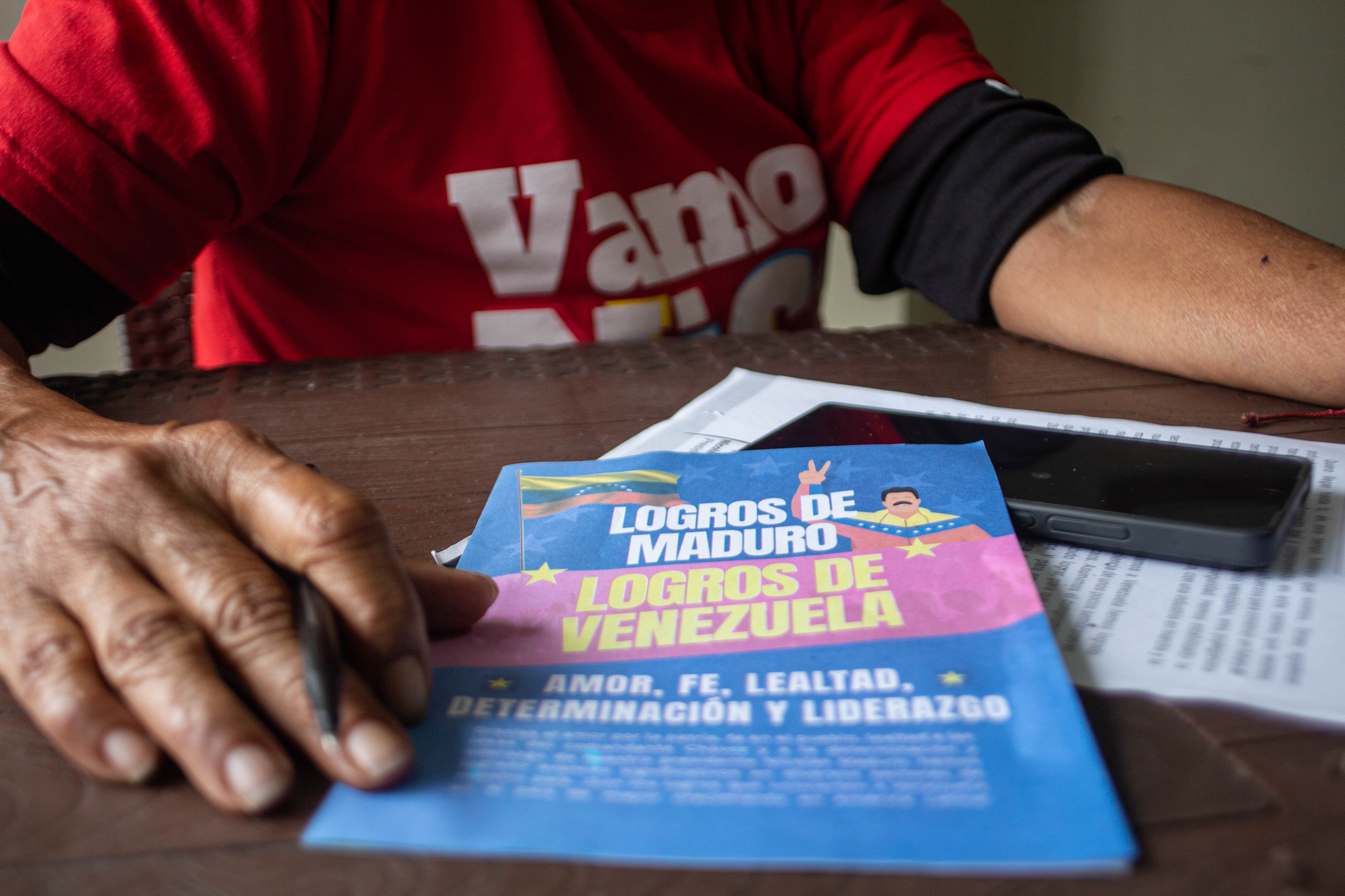 A pamphlet with a cartoon Maduro that reads in Spanish: "The accomplishments of Maduro, the accomplishments of Venezuela"