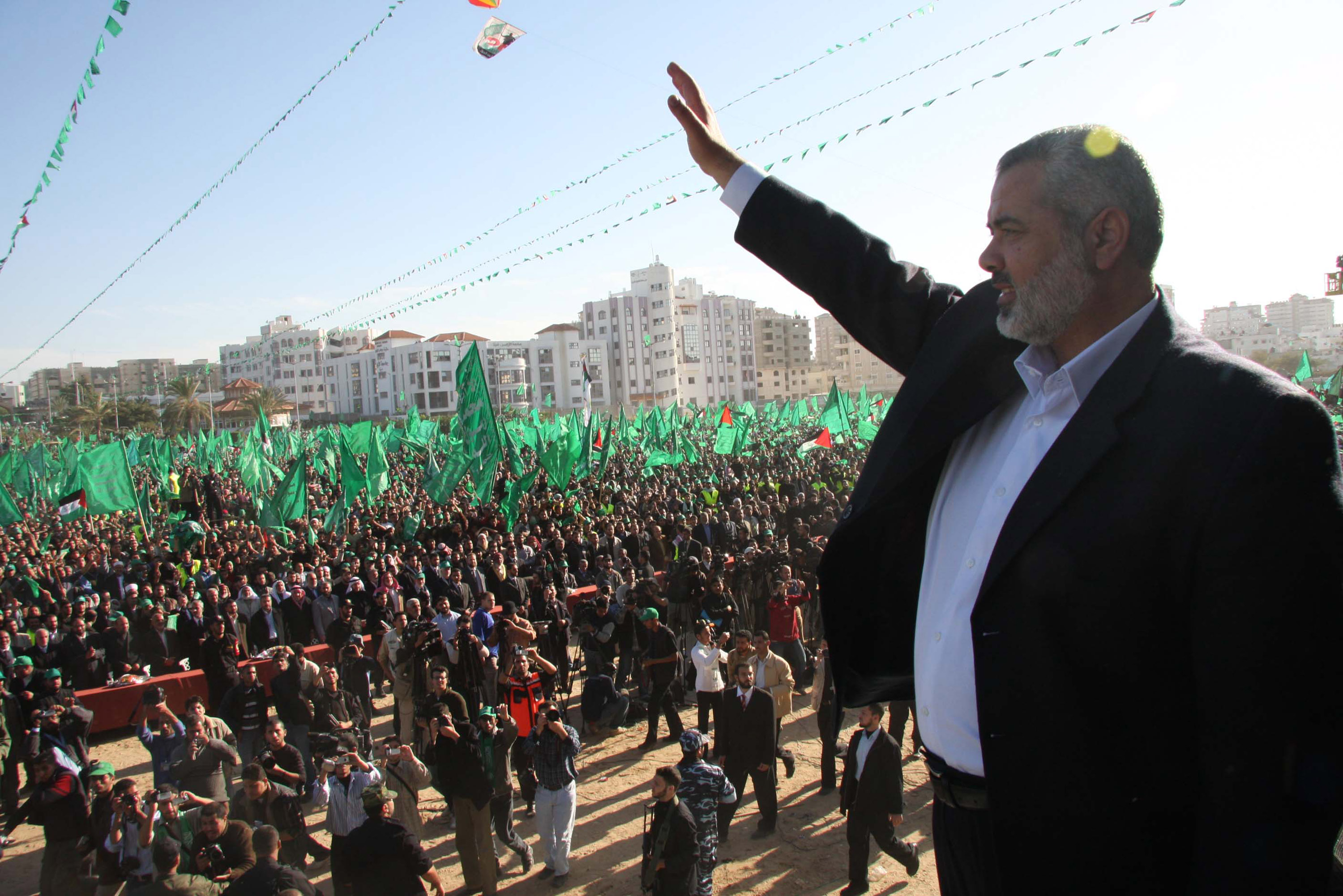 In this handout image supplied by the Palestinian Prime Minsters Office (PPM), Dismissed Palestinian Prime Minister and Hamas leader, Ismail Haniyeh, waves to his supporters during a rally December 15, 2007.