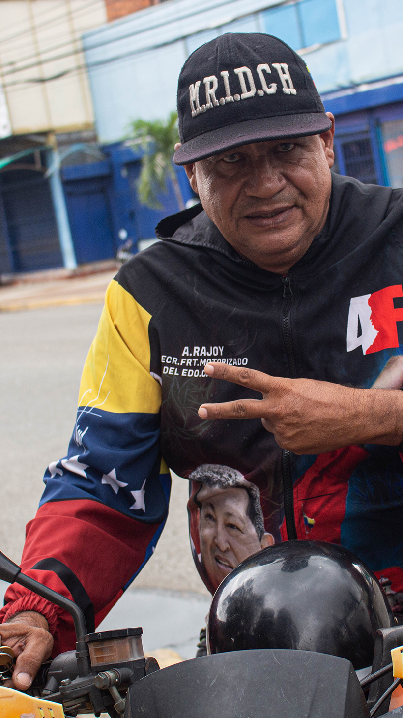 Alfredo Rojas wears a windbreaker jacket showing off his support for the late Hugo Chavez and Nicolas Maduro
