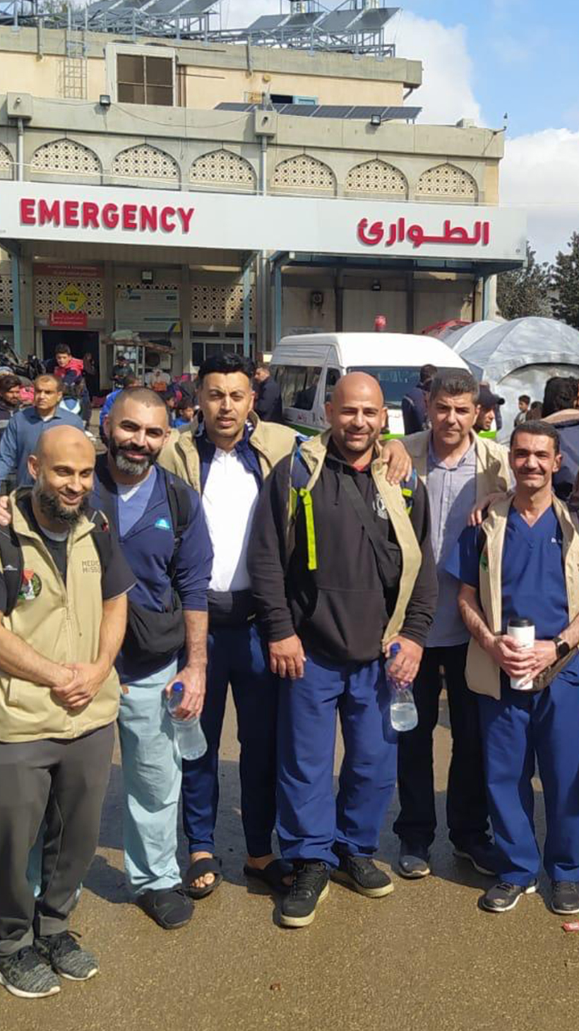A photo of medical professionals in Gaza, in front of an emergency room entrance.