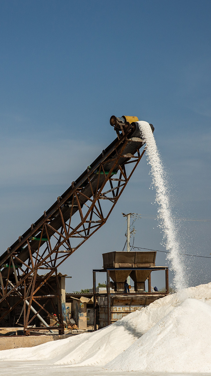 A piece of heavy machinery processes salt outdoors in La Guajira.