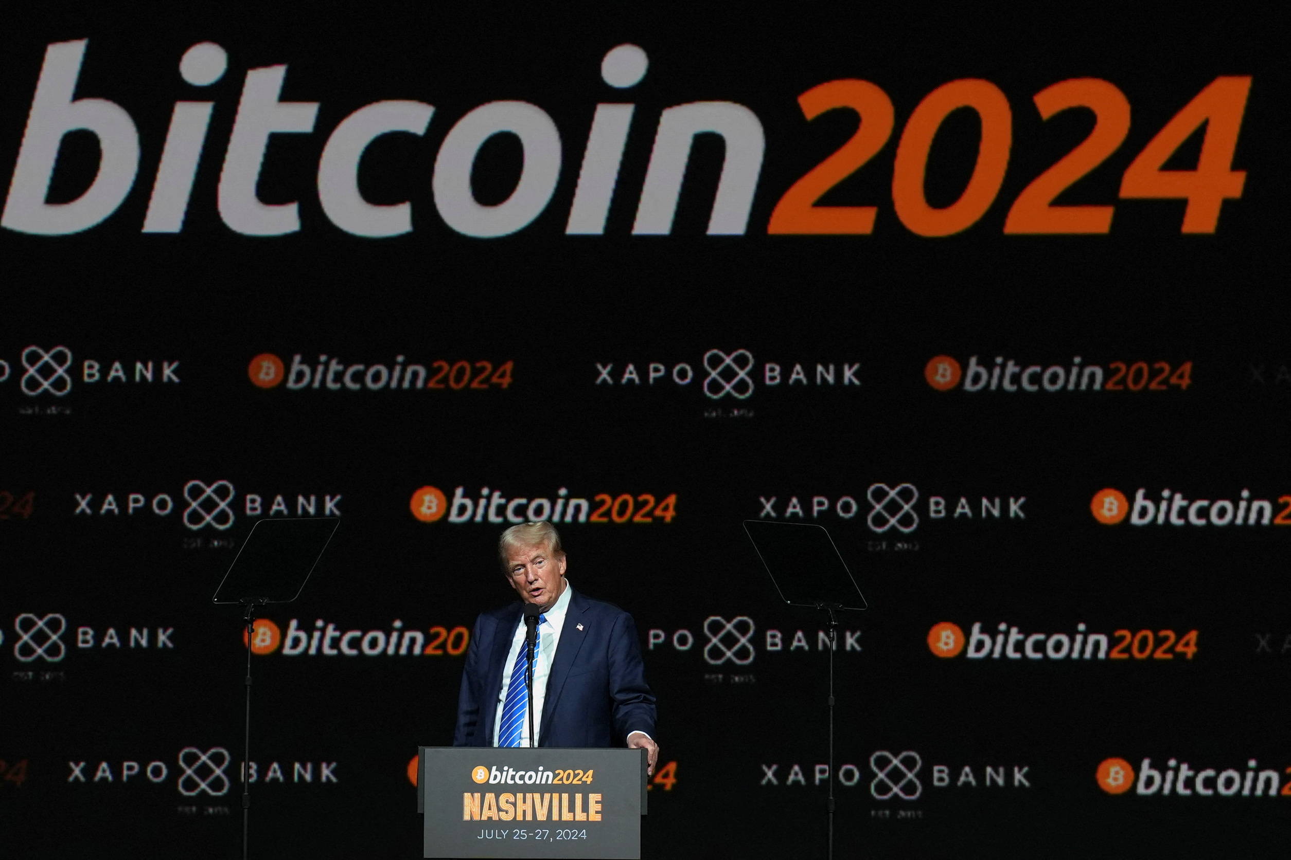 Trump with Bitcoin sign behind him