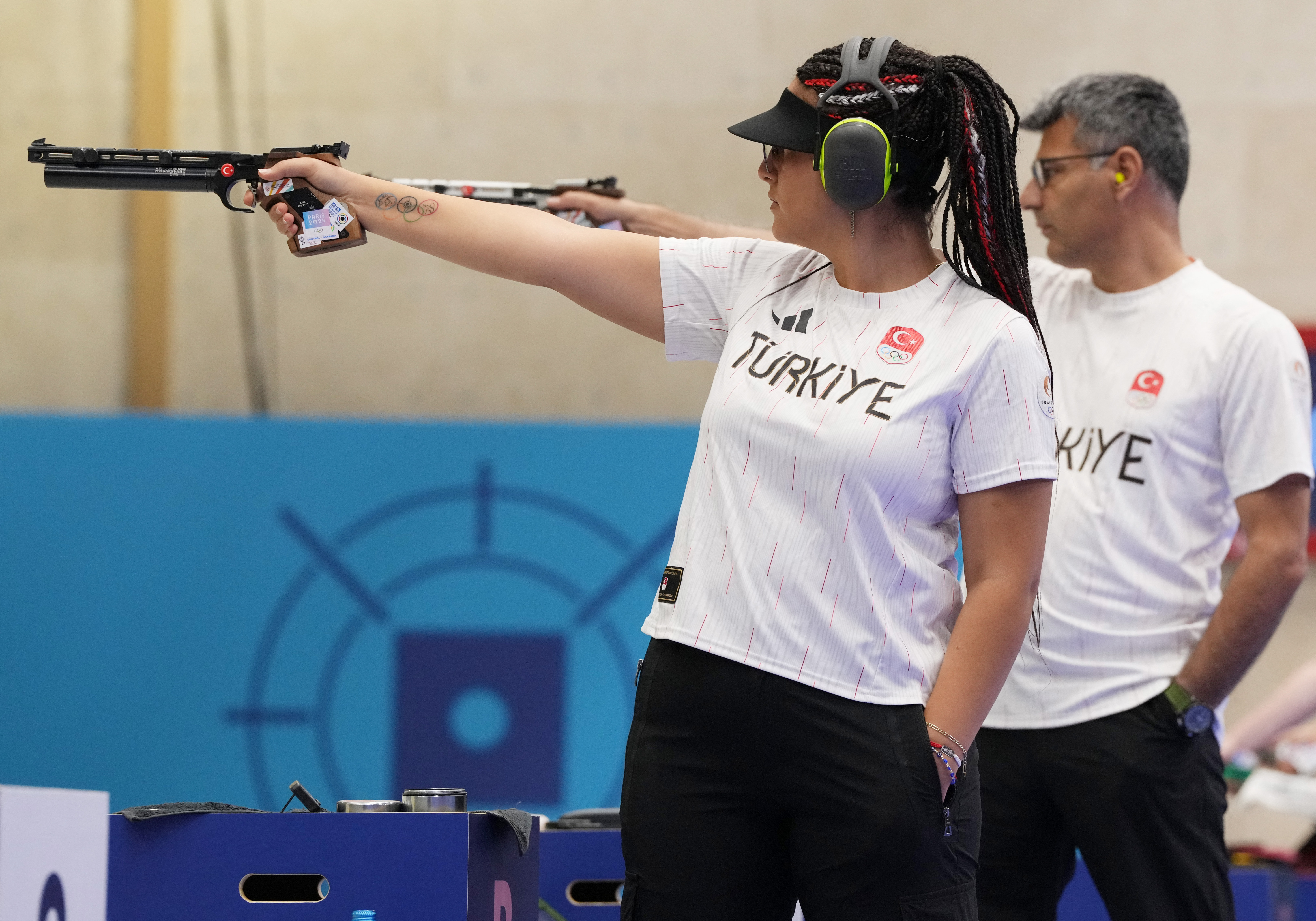 Paris 2024 Olympics - Shooting - 10m Air Pistol Mixed Team Gold Medal - Chateauroux Shooting Centre, Deols, France - July 30, 2024. Sevval Ilayda Tarhan of Turkey (L) and Yusuf Dikec of Turkey in action. REUTERS/Amr Alfiky