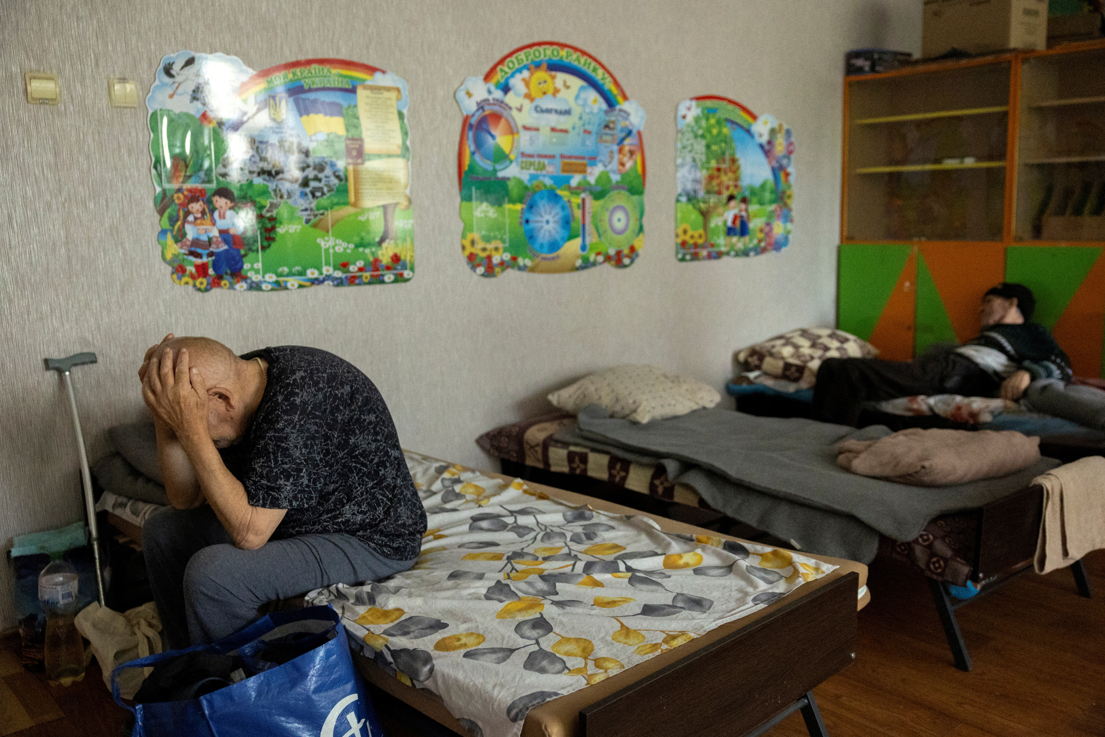 People who fled Russian shelling of villages in the Pokrovsk area sit in an evacuation centre in the Donetsk region, Ukraine, amid Russia's attack on Ukraine, July 30, 2024. REUTERS/Thomas Peter