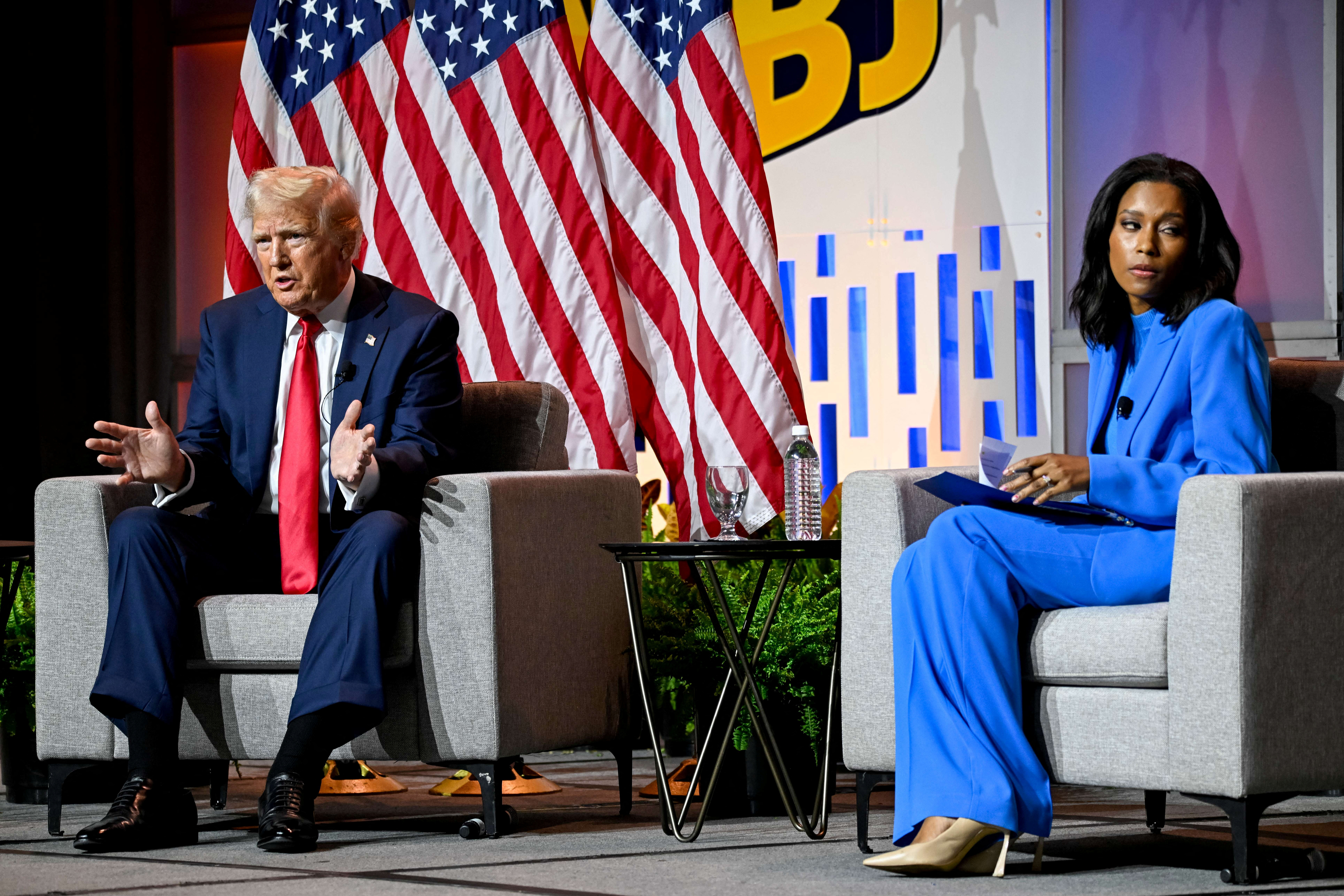 Republican presidential nominee and former US President Donald Trump speaks on a panel of the National Association of Black Journalists (NABJ) convention as Rachel Scott, senior congressional correspondent for ABC News, looks away, in Chicago, Illinois, on July 31, 2024. [File: Vincent Alban/Reuters]