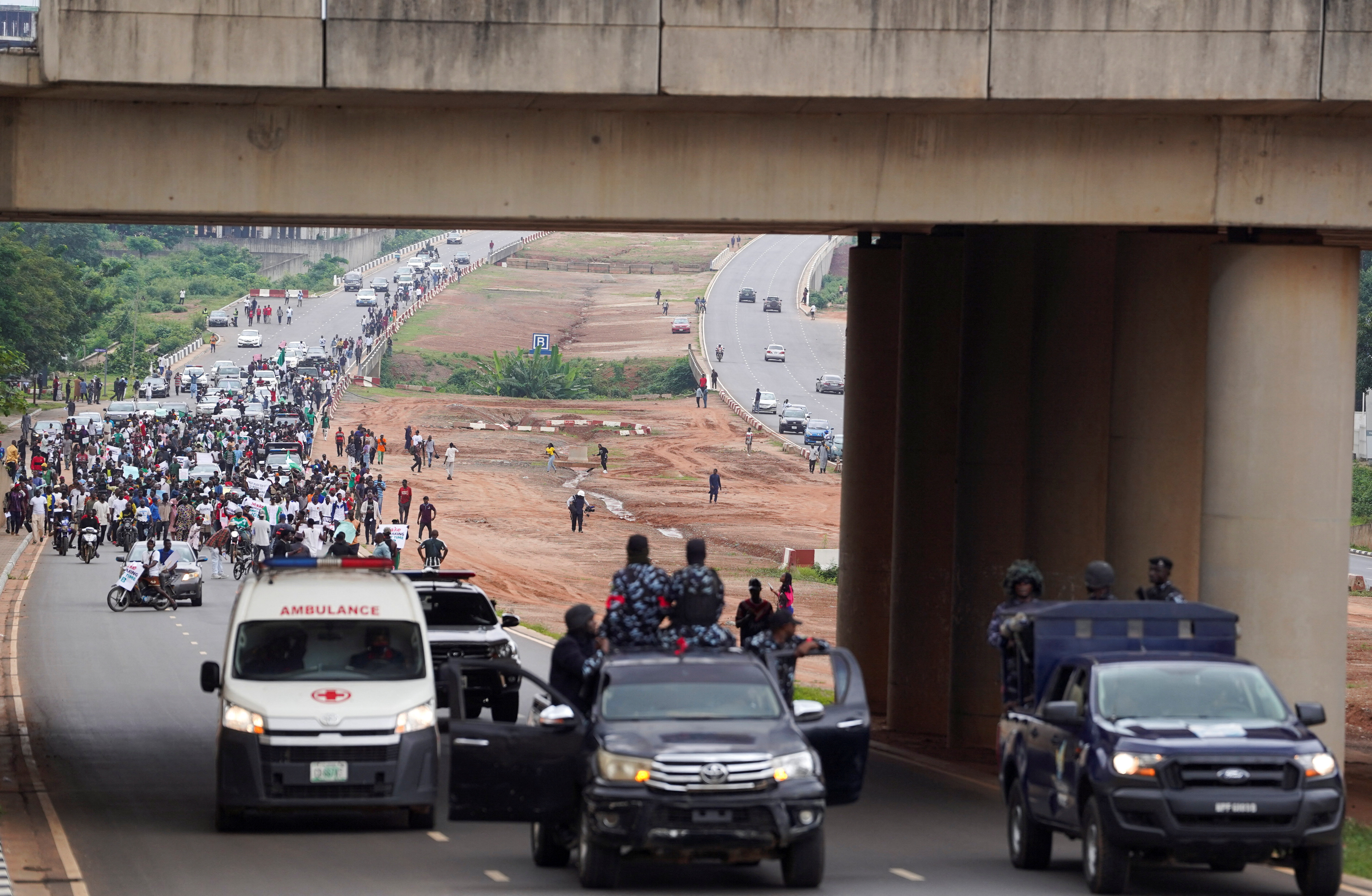 Nigerian security forces stand guard on a road, during the an anti-government demonstration to protest against bad governance and economic hardship