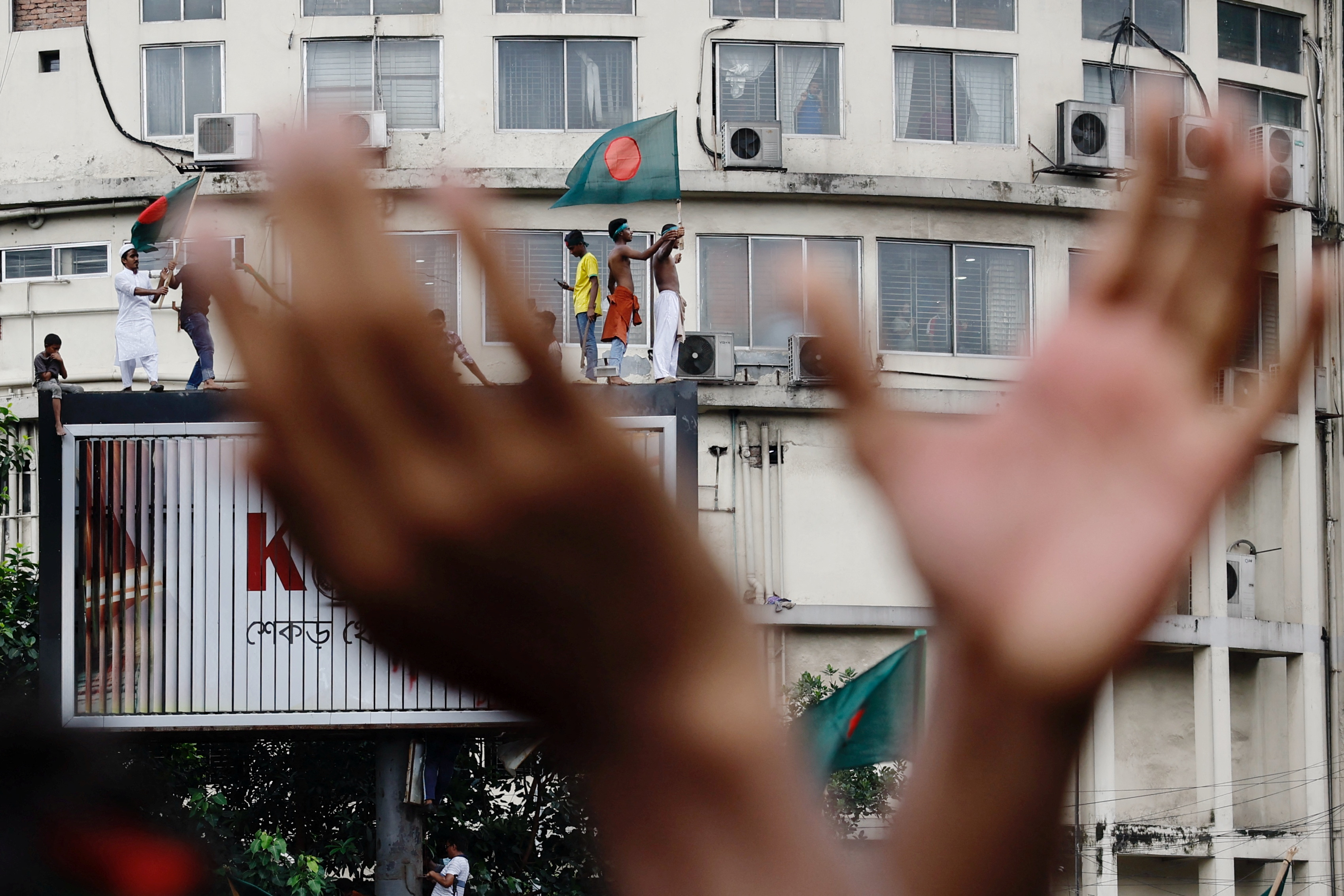 People celebrate the resignation of Bangladeshi Prime Minister Sheikh Hasina in Dhaka