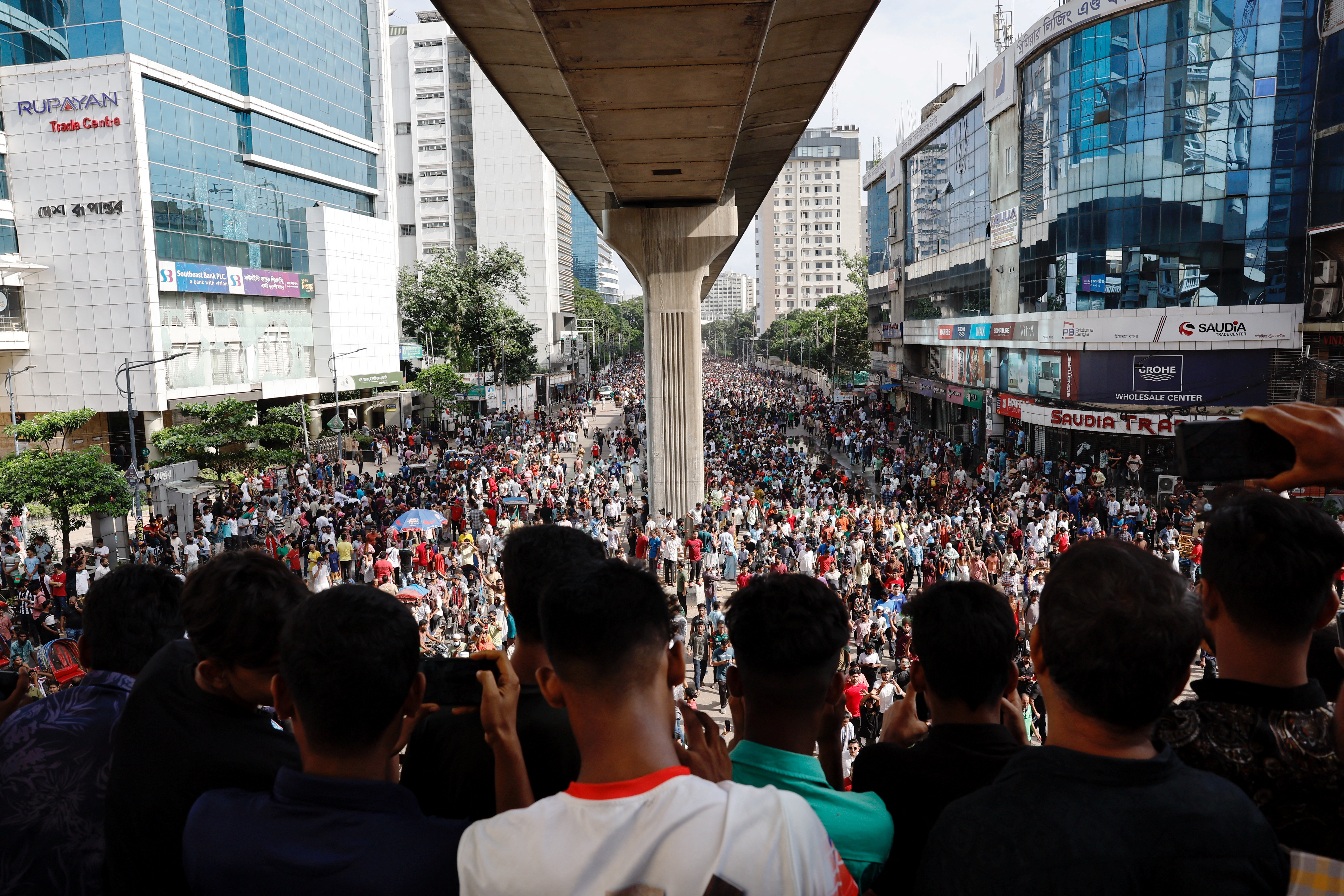 People celebrate the resignation of Bangladeshi Prime Minister Sheikh Hasina in Dhaka