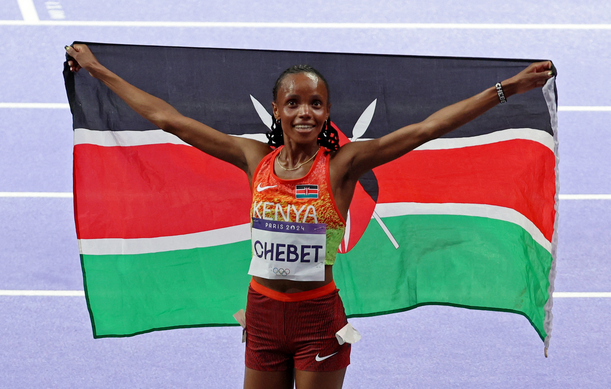Kenya's Beatrice Chebet celebrates after winning gold in women's 10,000-metre final [Phil Noble/Reuters]