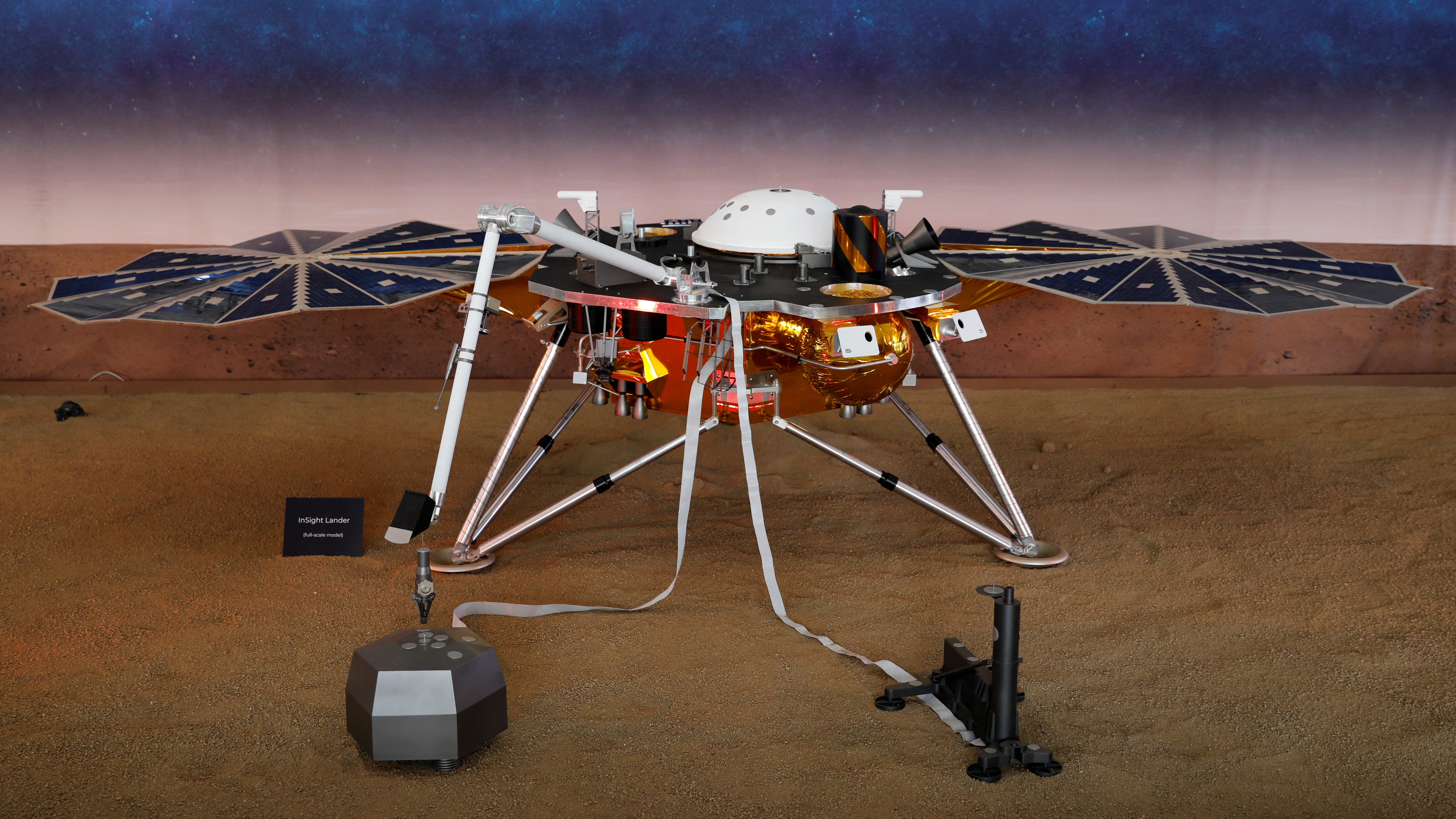 A life-size model of the spaceship Insight. It metal legs and a core with what look like round fans on either side.