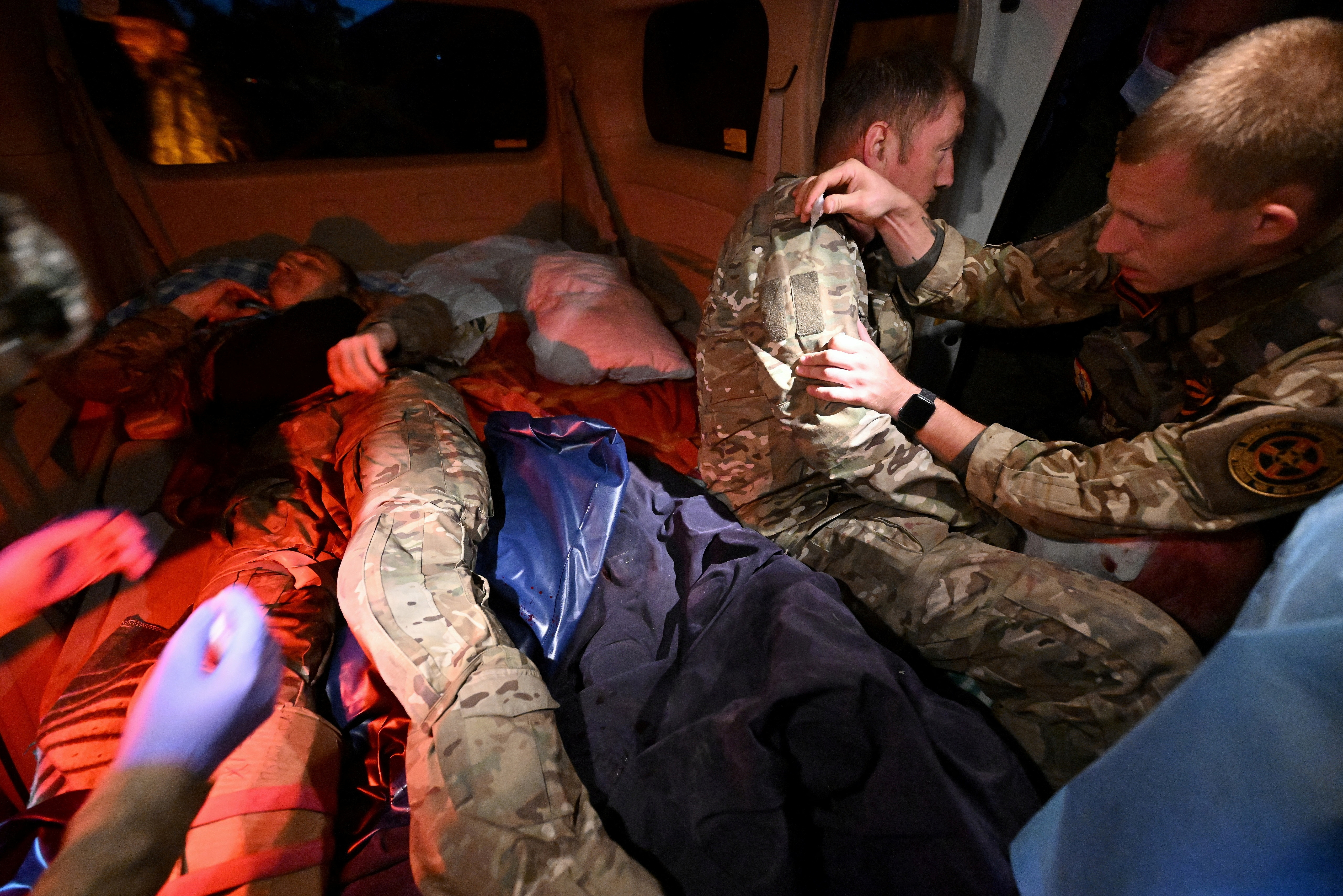 Medics provide assistance in a vehicle near a mobile medical station, which was opened by volunteers to treat wounded Russian military personnel and local residents, following an incursion of Ukrainian troops in the course of Russia-Ukraine conflict in the Kursk region, Russia August 11, 2024. Kommersant Photo/Anatoliy Zhdanov via REUTERS RUSSIA OUT. NO COMMERCIAL OR EDITORIAL SALES IN RUSSIA.