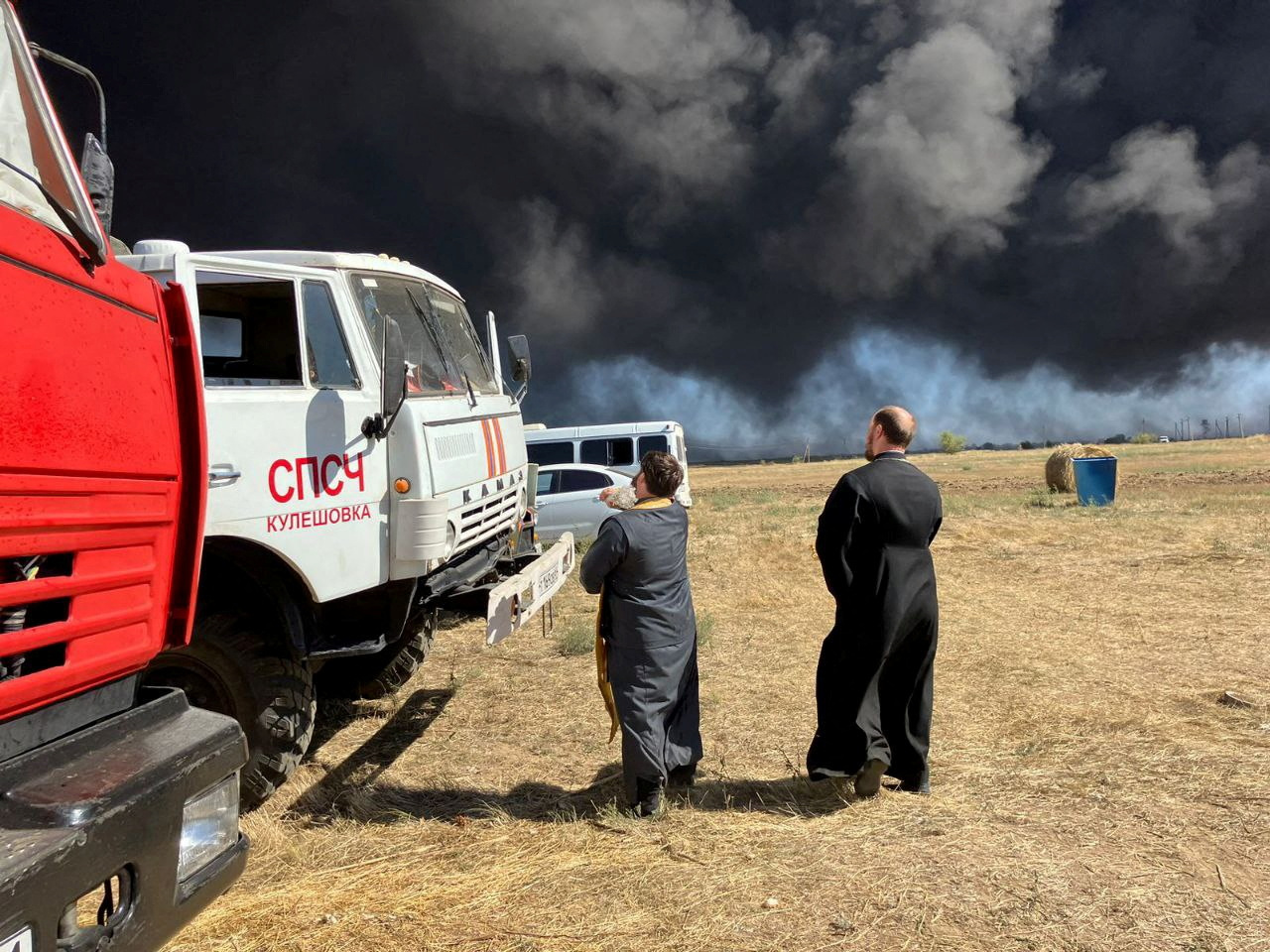 Russian Orthodox clergymen sprinkle holy water on fire trucks
