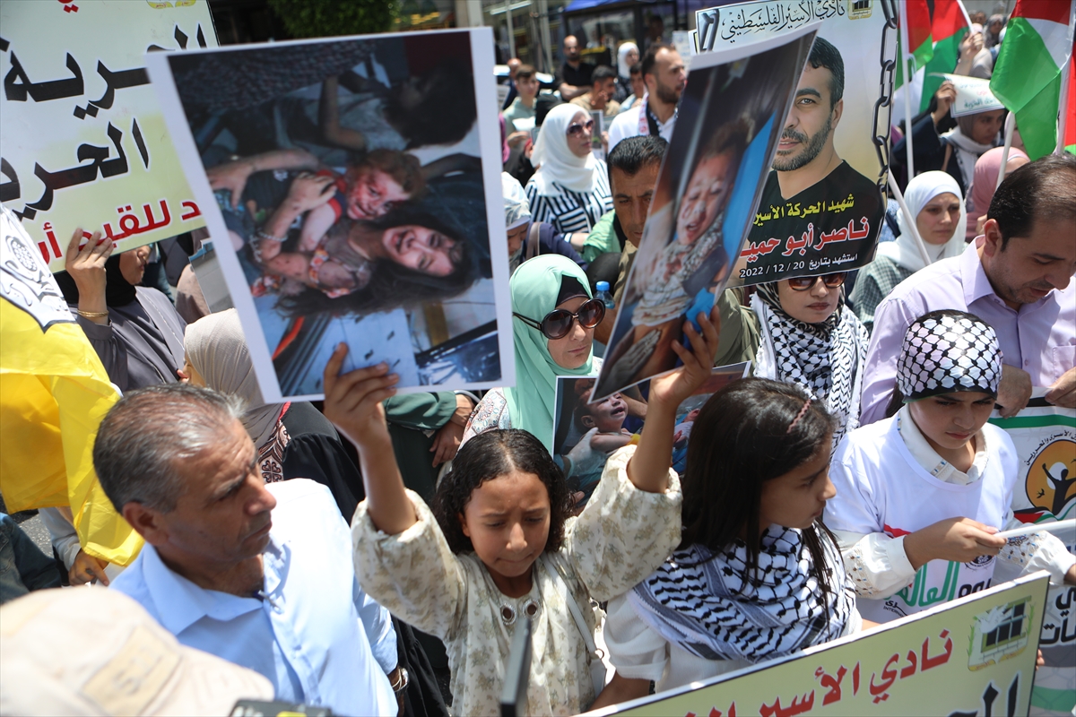 a girl holds up a poster at a protest