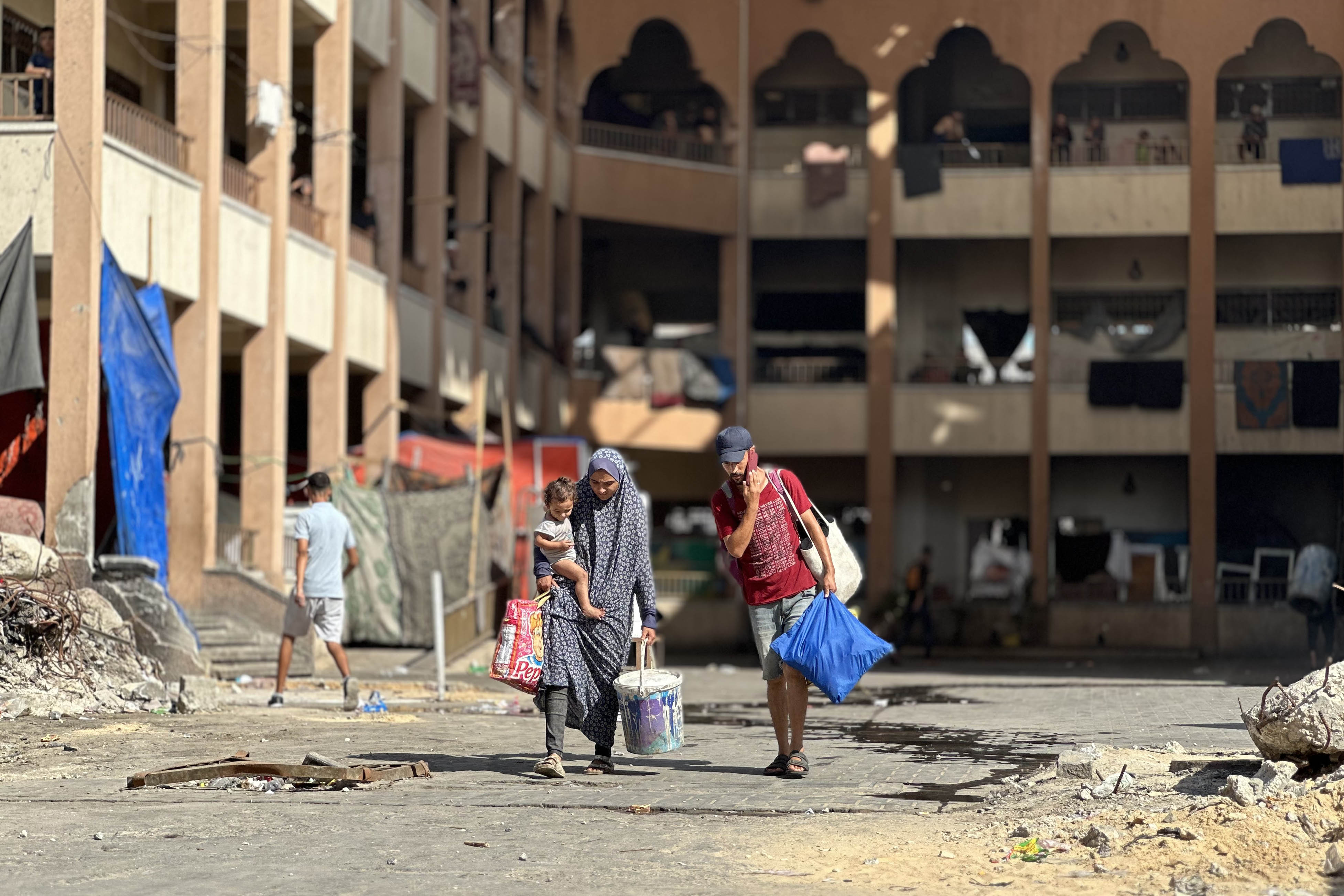 Displaced Palestinian kids make their way as they flee Hamad City following an Israeli evacuation order, amid Israel-Hamas conflict, in Khan Younis in the southern Gaza Strip August 11, 2024. REUTERS/Hatem Khaled