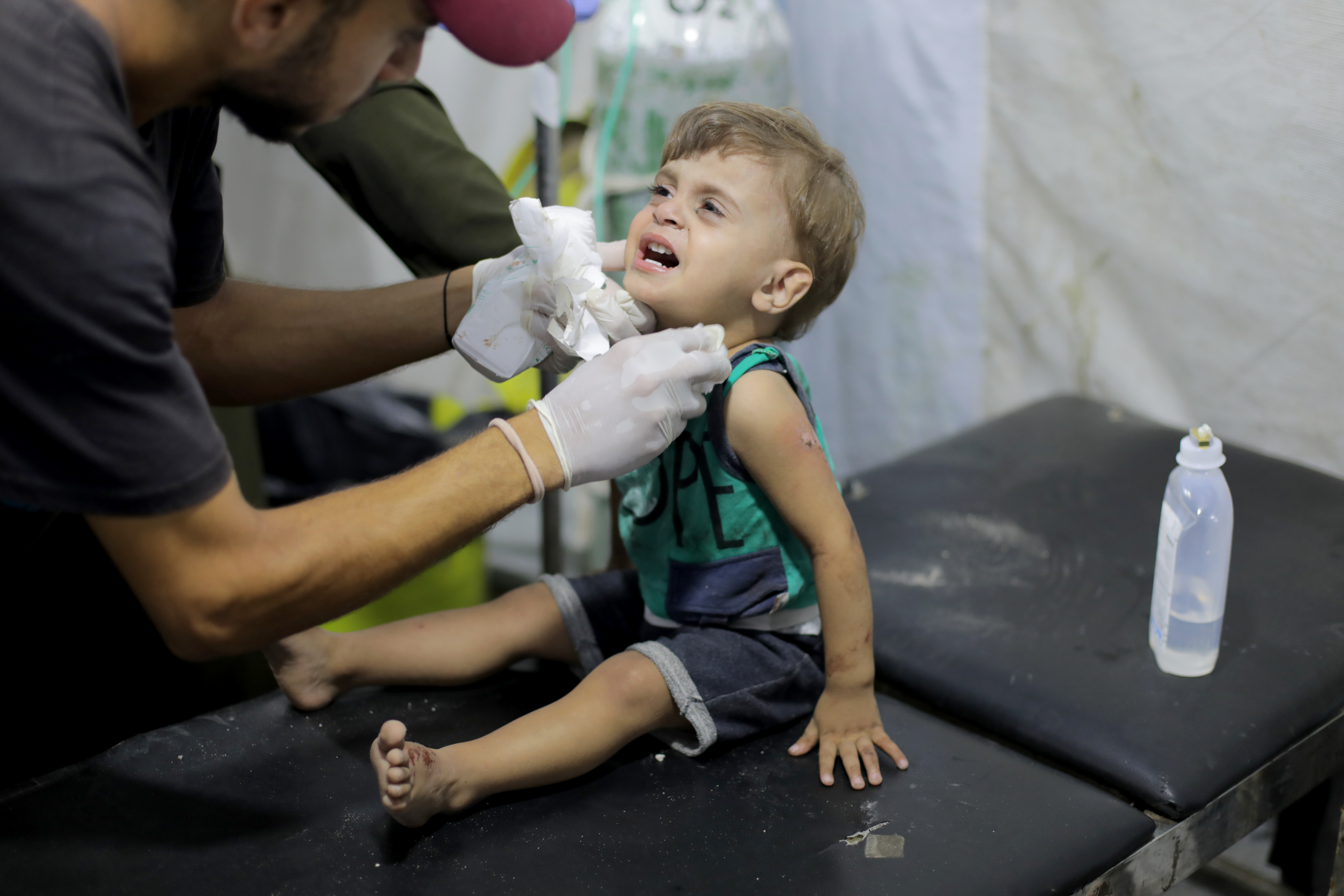 A medic checks up an injured child