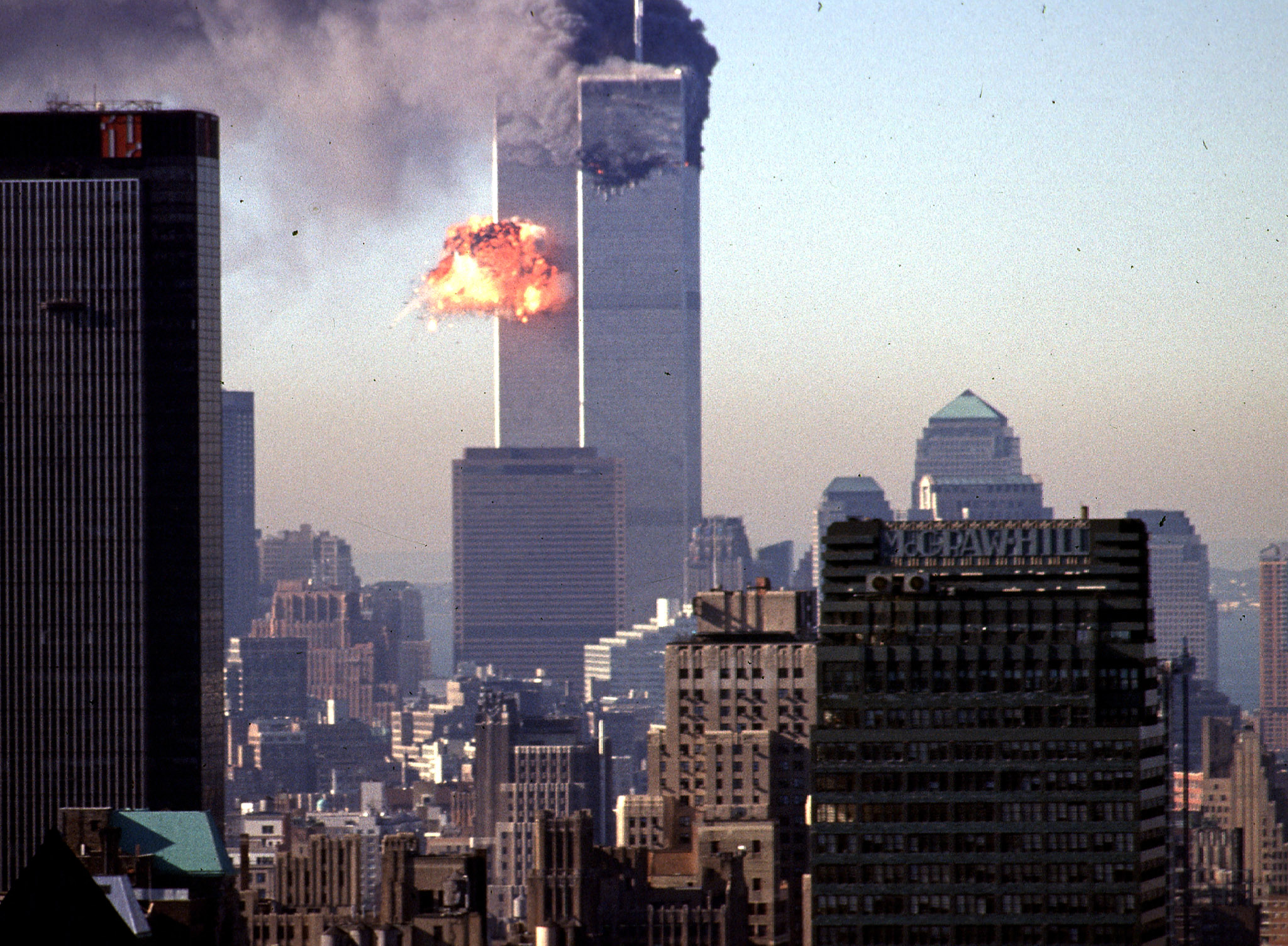 Smoke and flames billow from one of the World Trade Center's two towers after it was struck by a hijacked commercial aircraft.