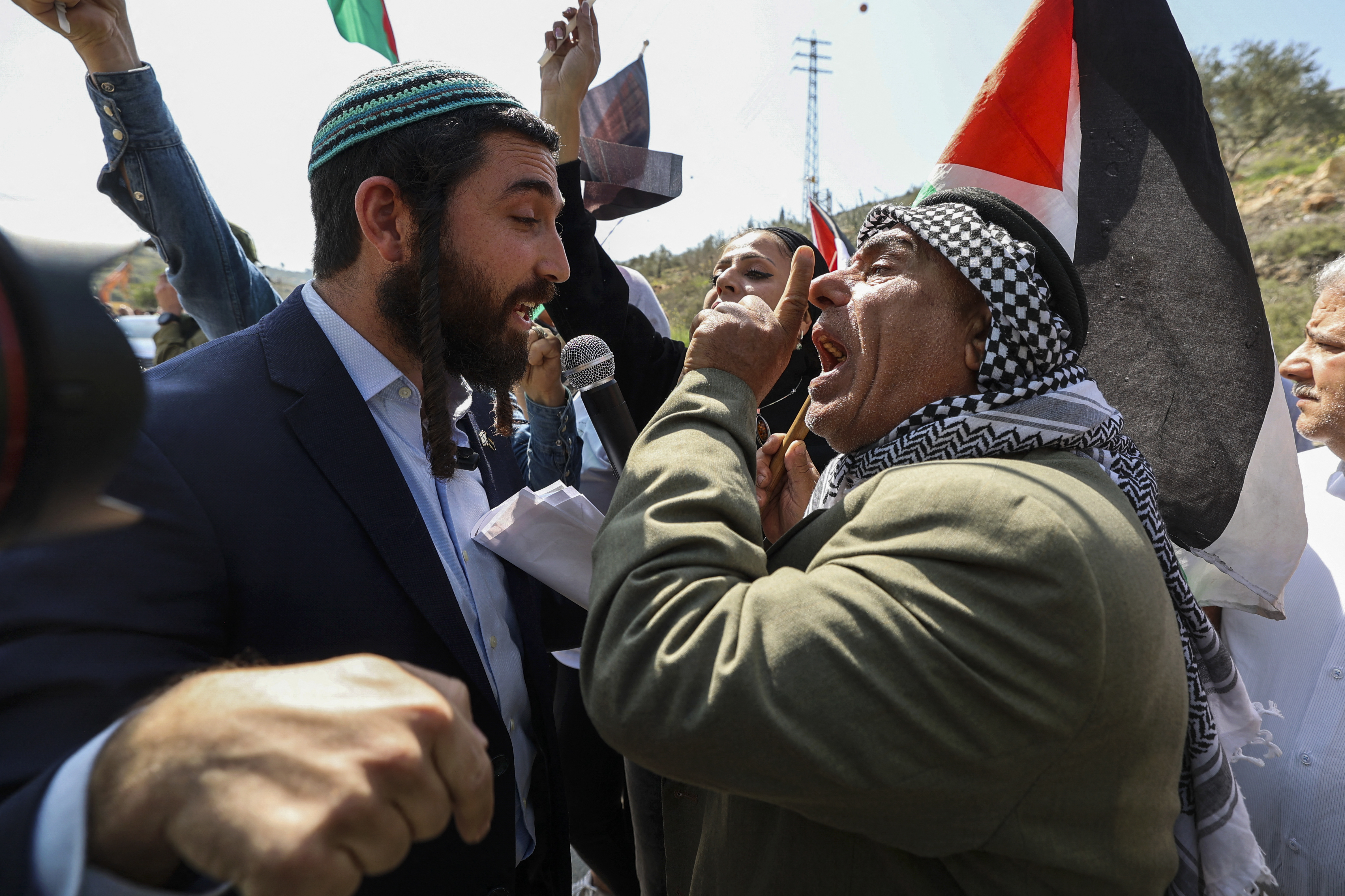 Knesset (Parliament) member for Israel's Religious Zionism party Tzvi Sukkot (L) is confronted as he tries to interrupt a rally by Palestinian and Israeli peace activists protesting at the entrance of Huwara in the occupied West Bank, on March 3, 2023, following deadly violence by Israeli settlers. (Photo by JAAFAR ASHTIYEH / AFP)