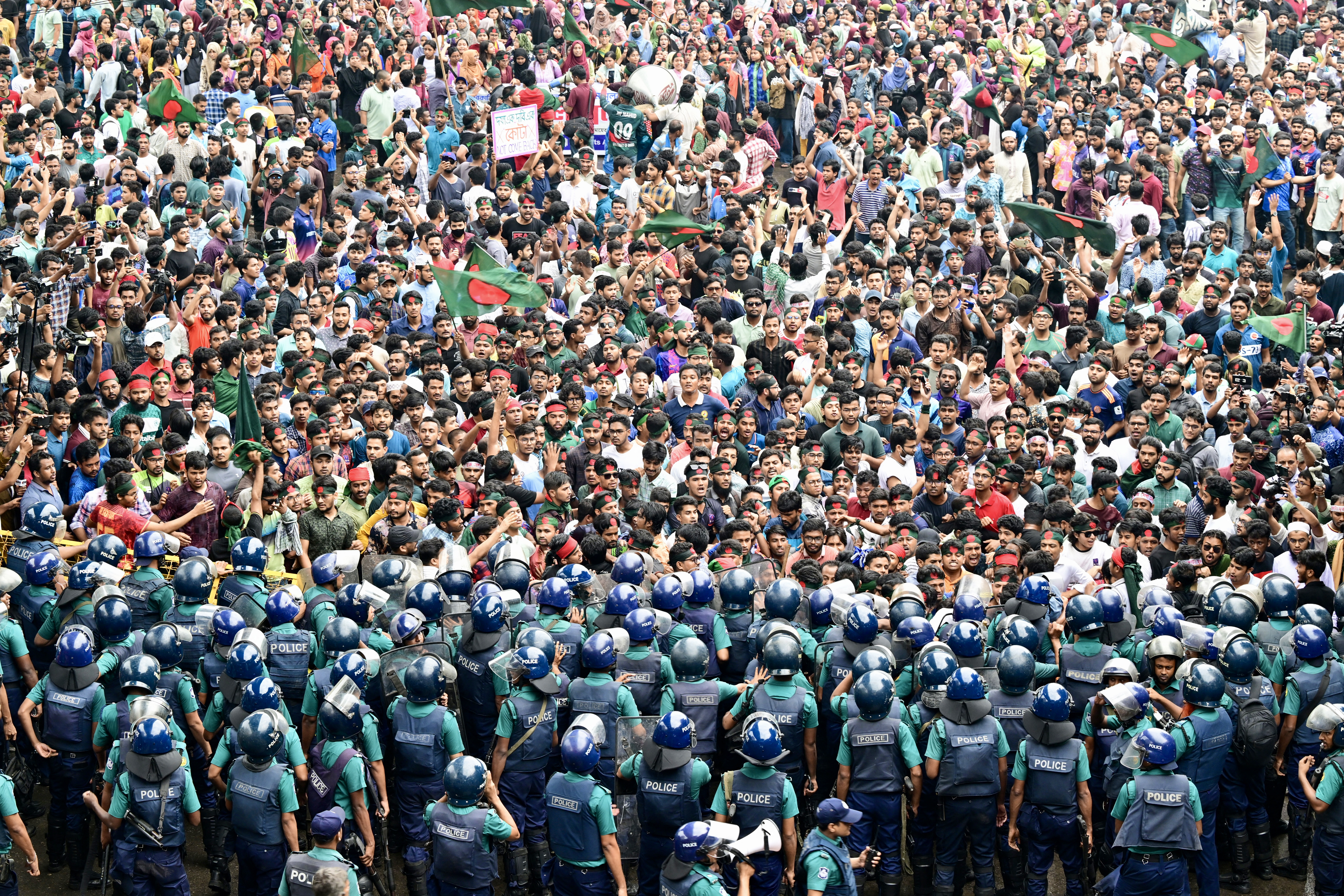 Students scuffle with police during a protest to demand merit-based system for civil service jobs in Dhaka on July 11, 2024. Bangladesh police on July 11 fired tear gas and rubber bullets to disperse university student protesters demanding the scrapping of quotas they say are rigged to support pro-government job candidates. (Photo by MUNIR UZ ZAMAN / AFP)