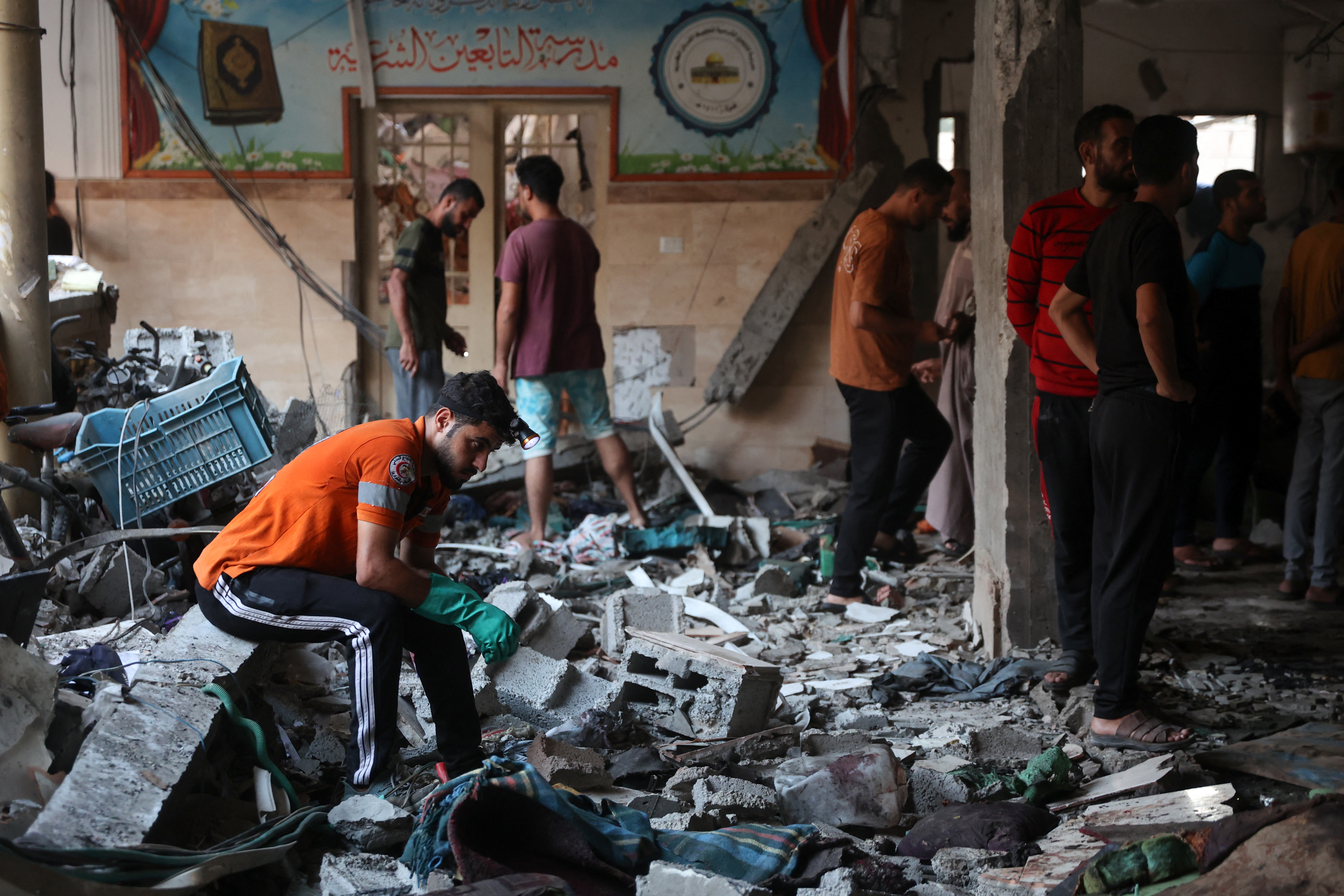 People check the damage inside a school used as a temporary shelter for displaced Palestinians in Gaza City, following an Israeli strike on August 10, 2024, that killed more than 90 people. (Photo by Omar AL-QATTAA / AFP)