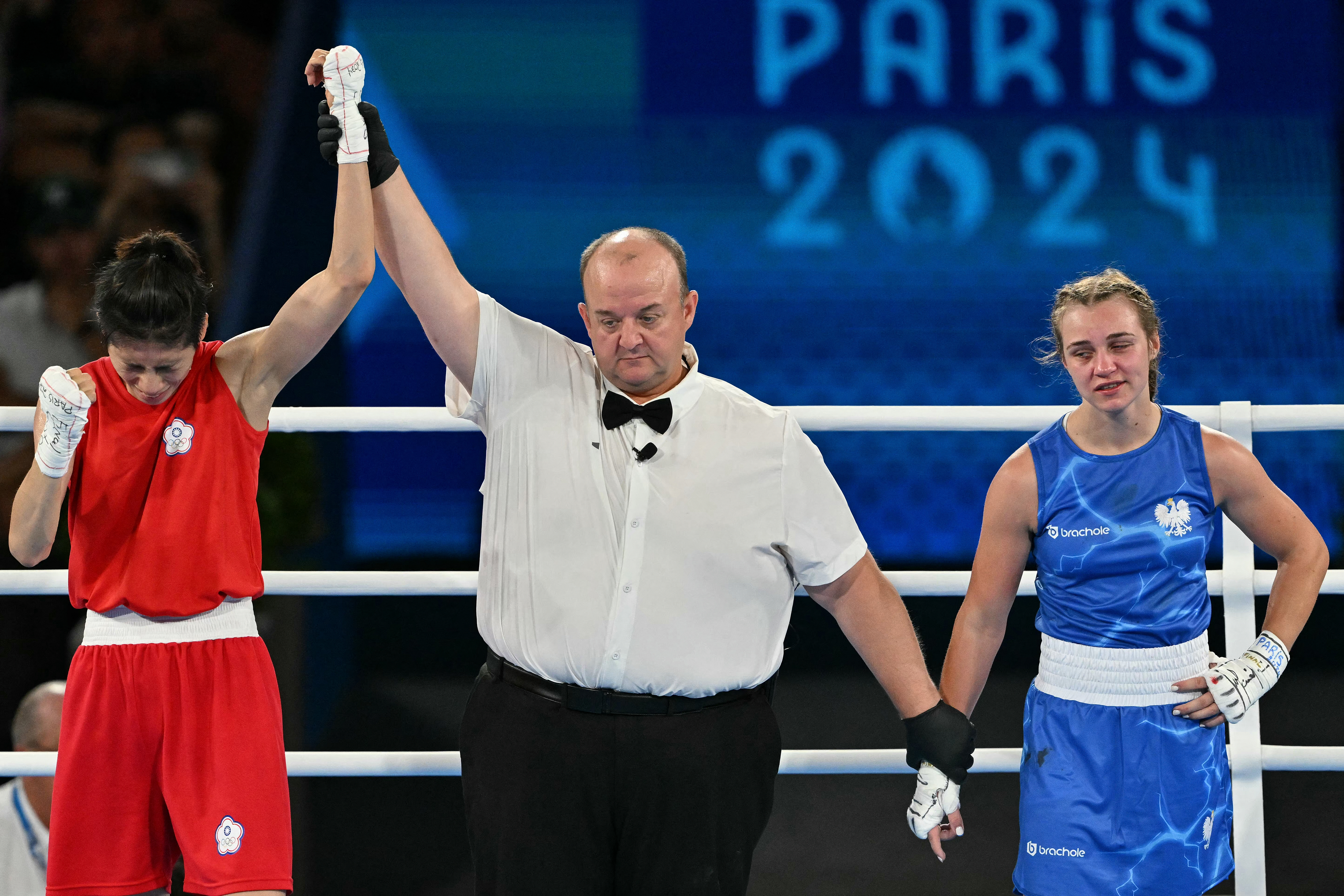 Taiwan's Lin Yu-ting reacts after beating Poland's Julia Szeremeta (Blue) in the women's 57kg final boxing match during the Paris 2024 Olympic Games at the Roland-Garros Stadium, in Paris on August 10, 2024. (Photo by MOHD RASFAN / AFP)