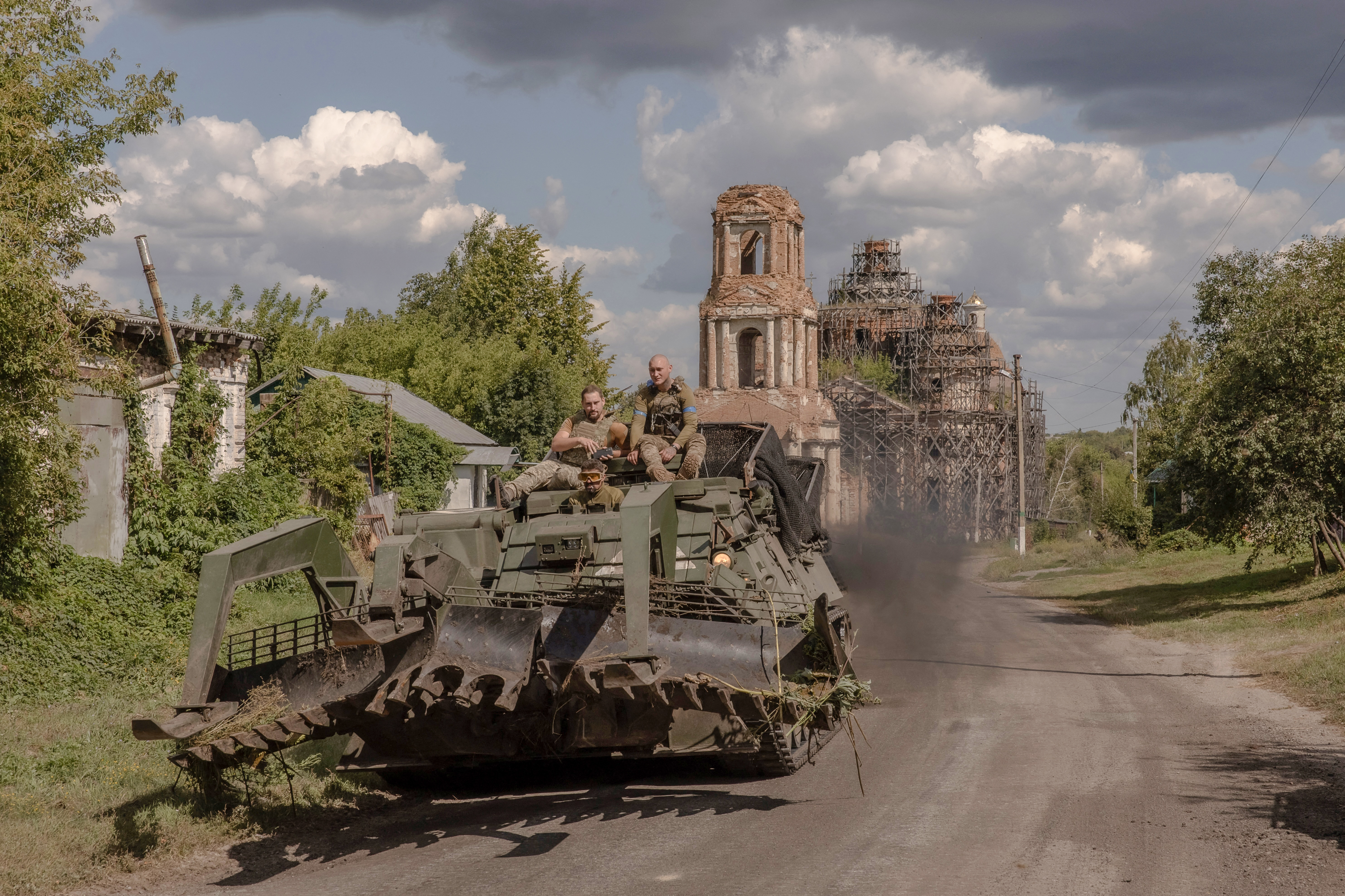 Ukrainian servicemen operate an armoured military vehicle on a road near the border with Russia