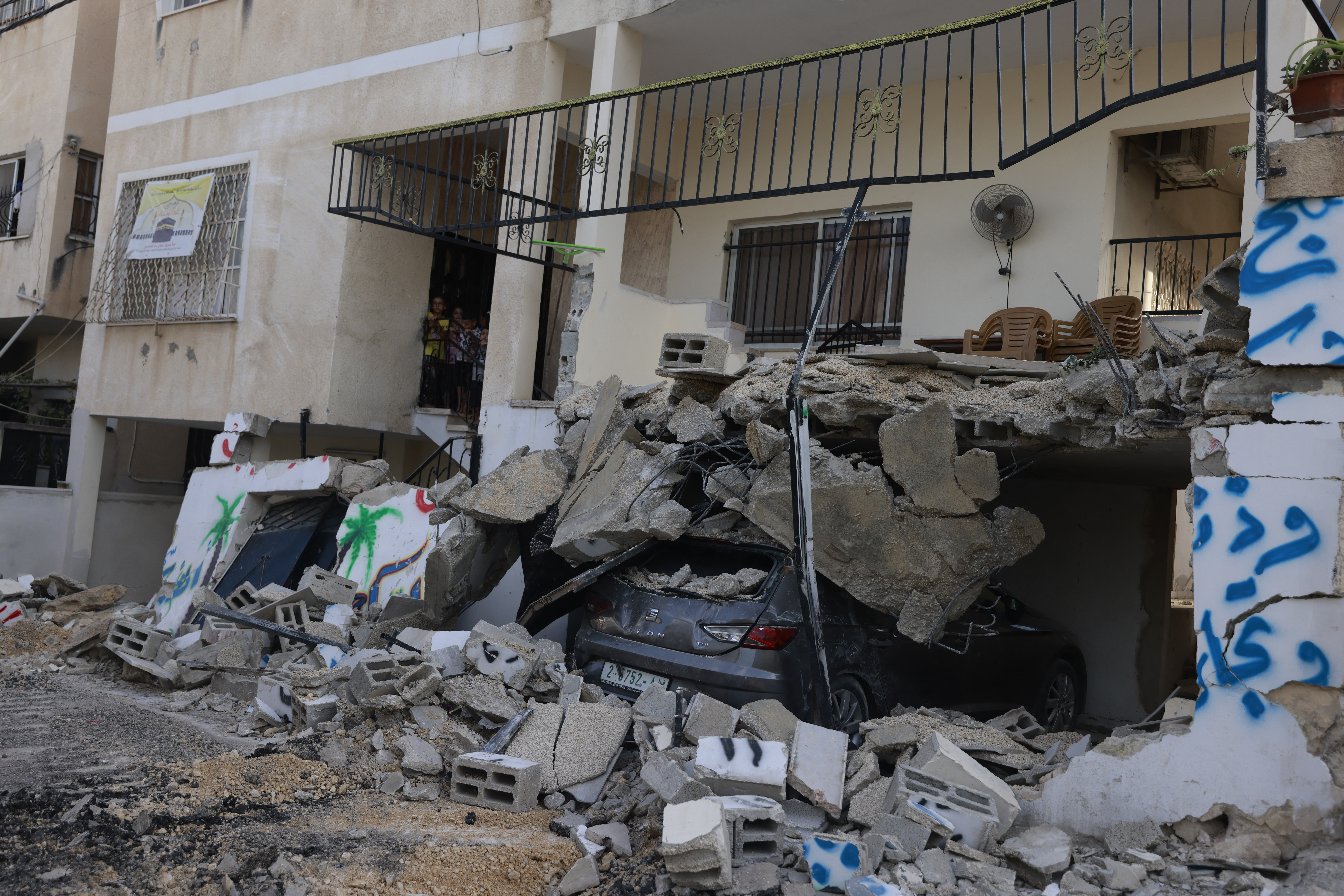 The largest Israeli military raid on the occupied West Bank in decades continues with at least 12 Palestinians killed and dozens wounded after the first day of the incursion on Wednesday.