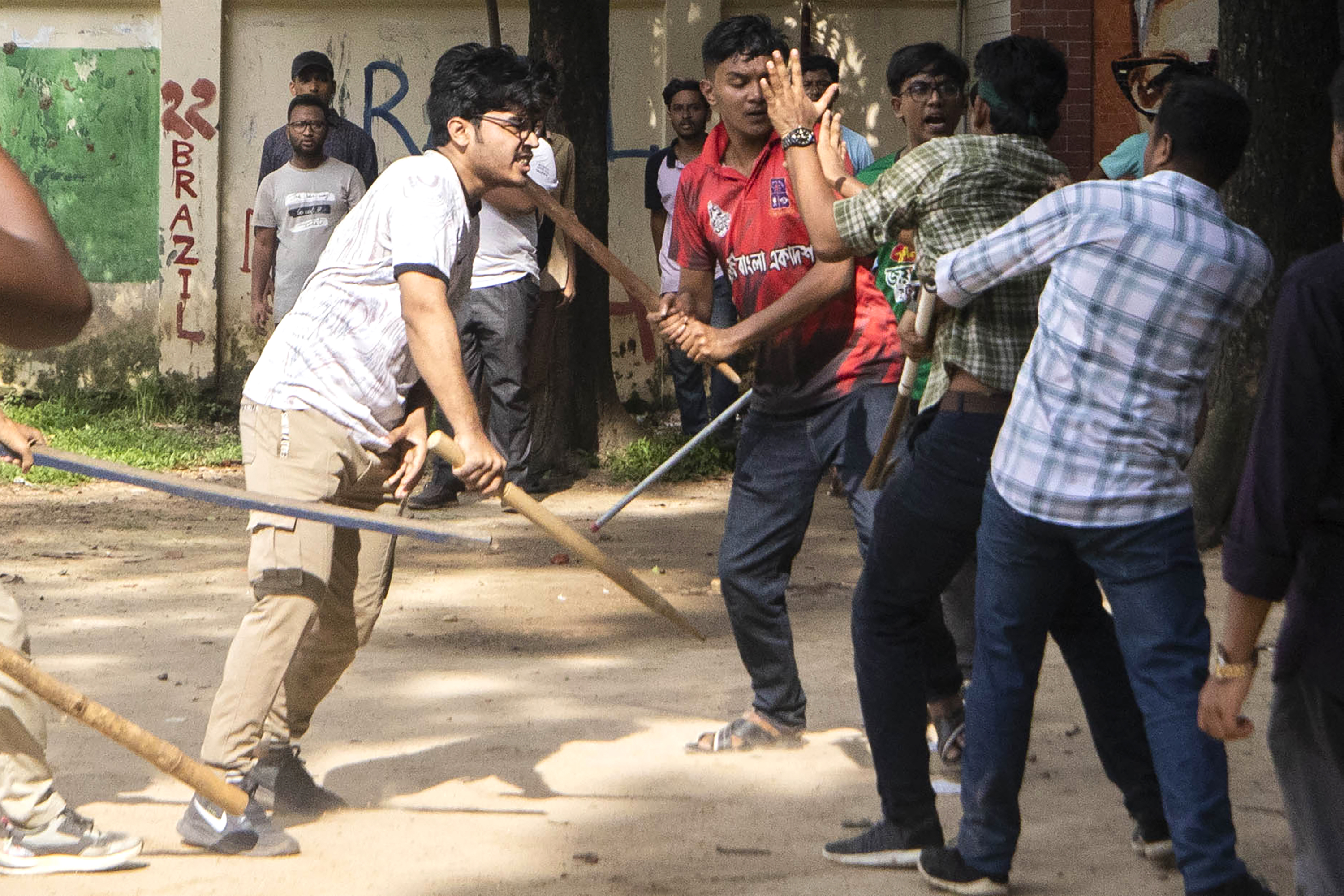 Students clash over quota system at Jahangir Nagar University at Savar outside Dhaka, Bangladesh, Monday, July 15, 2024. Police have fired tear gas and charged with batons overnight during violent clashes between a pro-government student body and student protesters, leaving dozens injured at a leading public university outside Bangladesh's capital over quota system in government jobs, police and students said Tuesday.(AP Photo/Abdul Goni)
