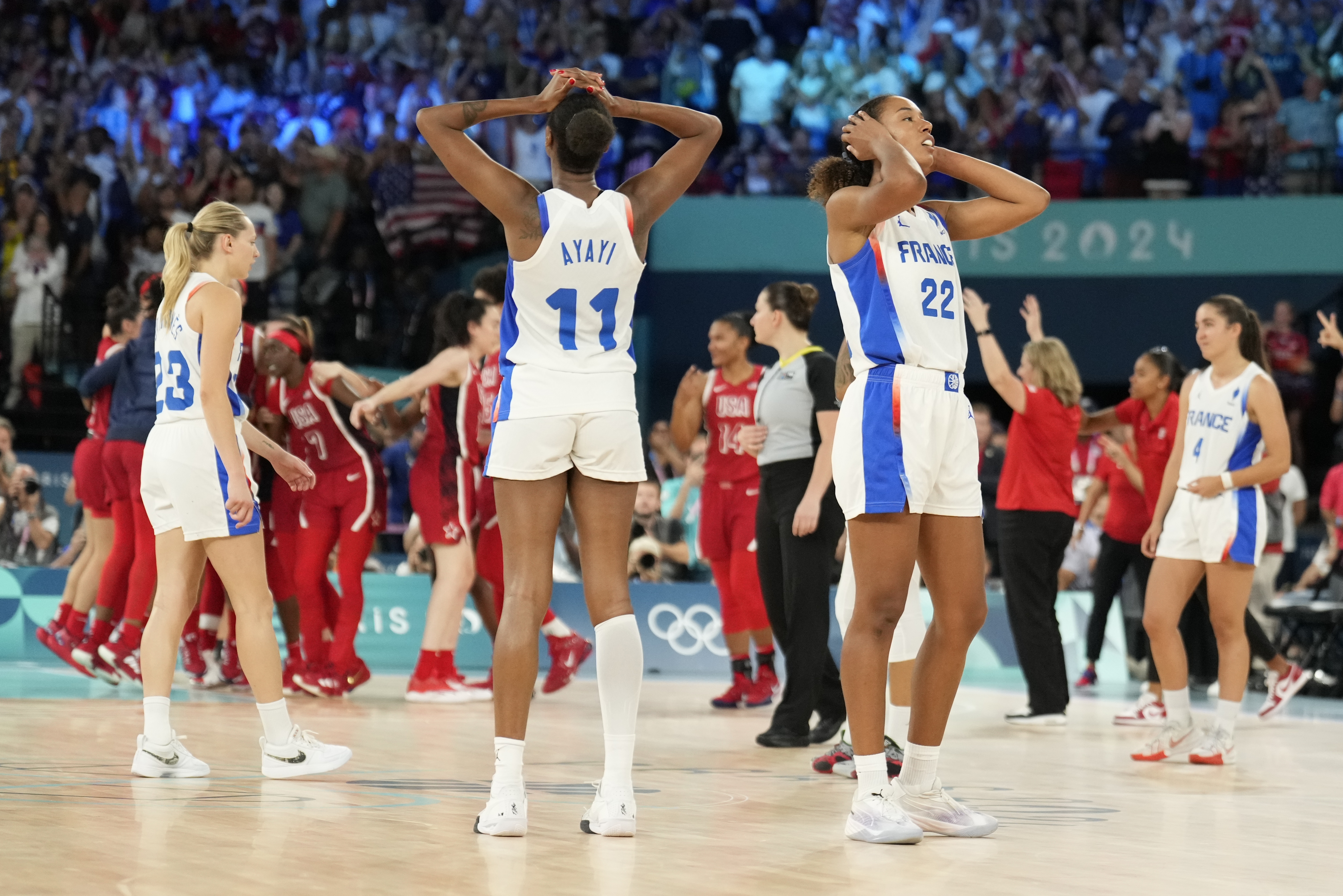 Valeriane Ayayi (11), of France, and Marieme Badiane (22), of France, react after a women's gold medal basketball game at Bercy Arena at the 2024 Summer Olympics, Sunday, Aug. 11, 2024, in Paris, France. (AP Photo/Mark J. Terrill)