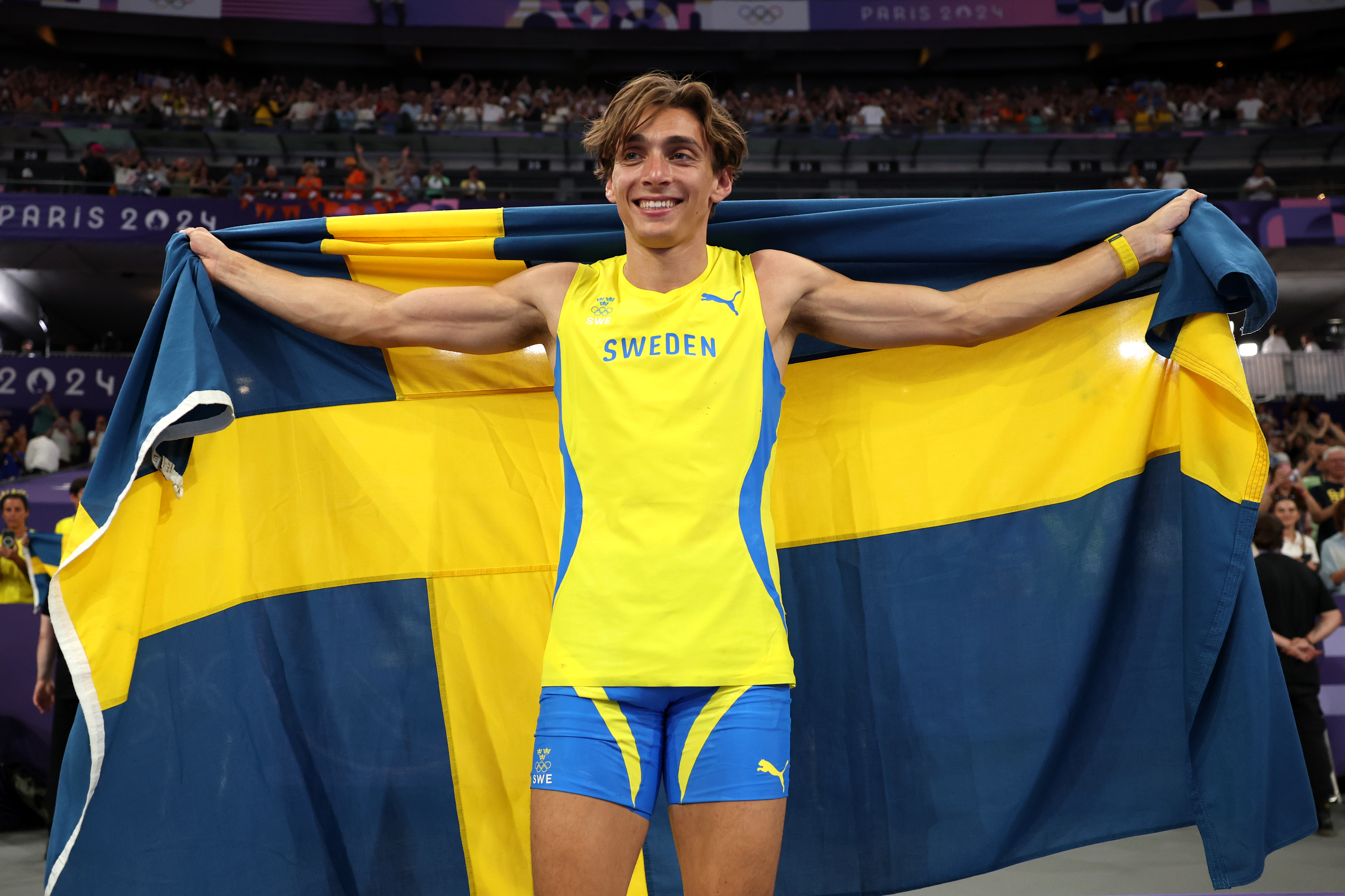 Pole vaulter celebrates victory.