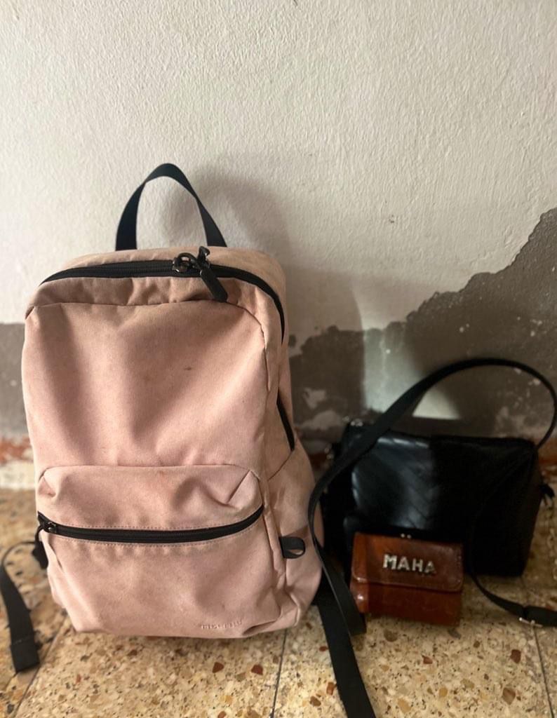 Maha Hussaini takes extra good care of the bag she grabbed when she left her home in Gaza, holding on to the links she has with home as Israel continues its attack on Gaza