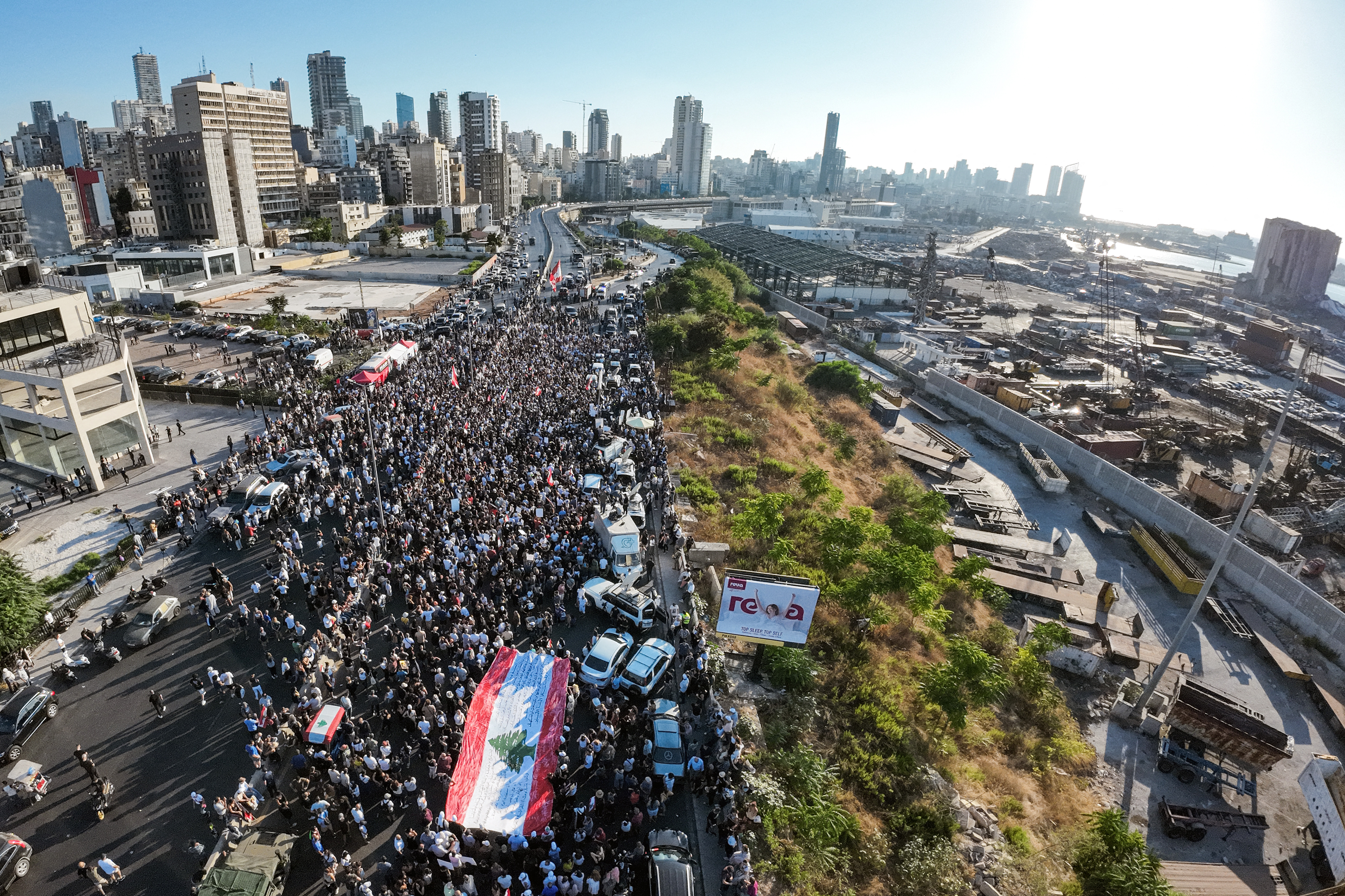 Demonstrators march outside the port of Beirut on August 4, 2023, to mark the third anniversary of the deadly harbour explosion which devastated large swathes of the Lebanese capital in 2020 [File: Kameel RAYES / AFP]