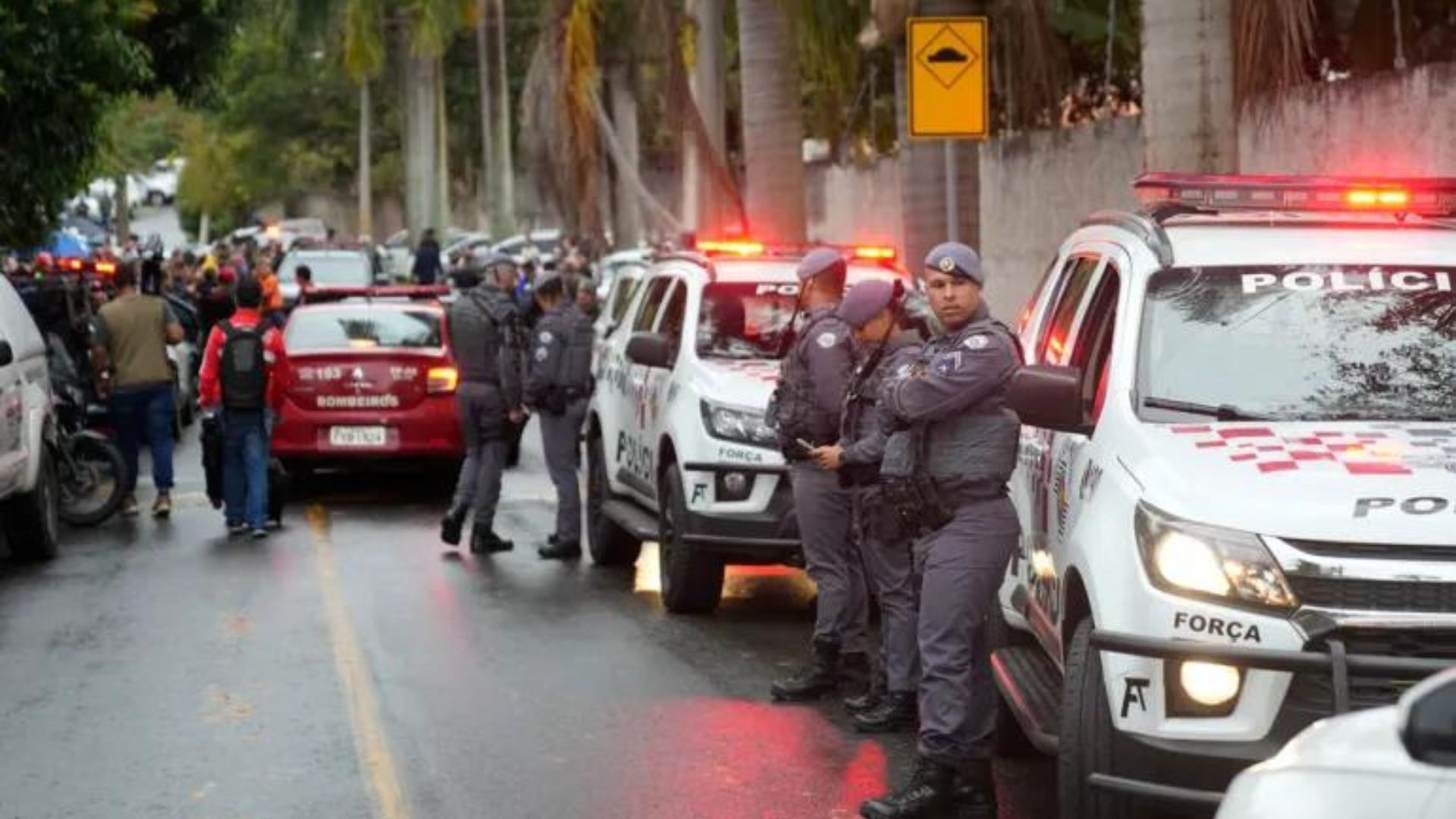 Police stand along the street leading to the gated community where a plane crashed in Vinhedo, Sao Paulo state, Brazil, Friday, Aug. 9, 2024. (AP Photo/Andre Penner)